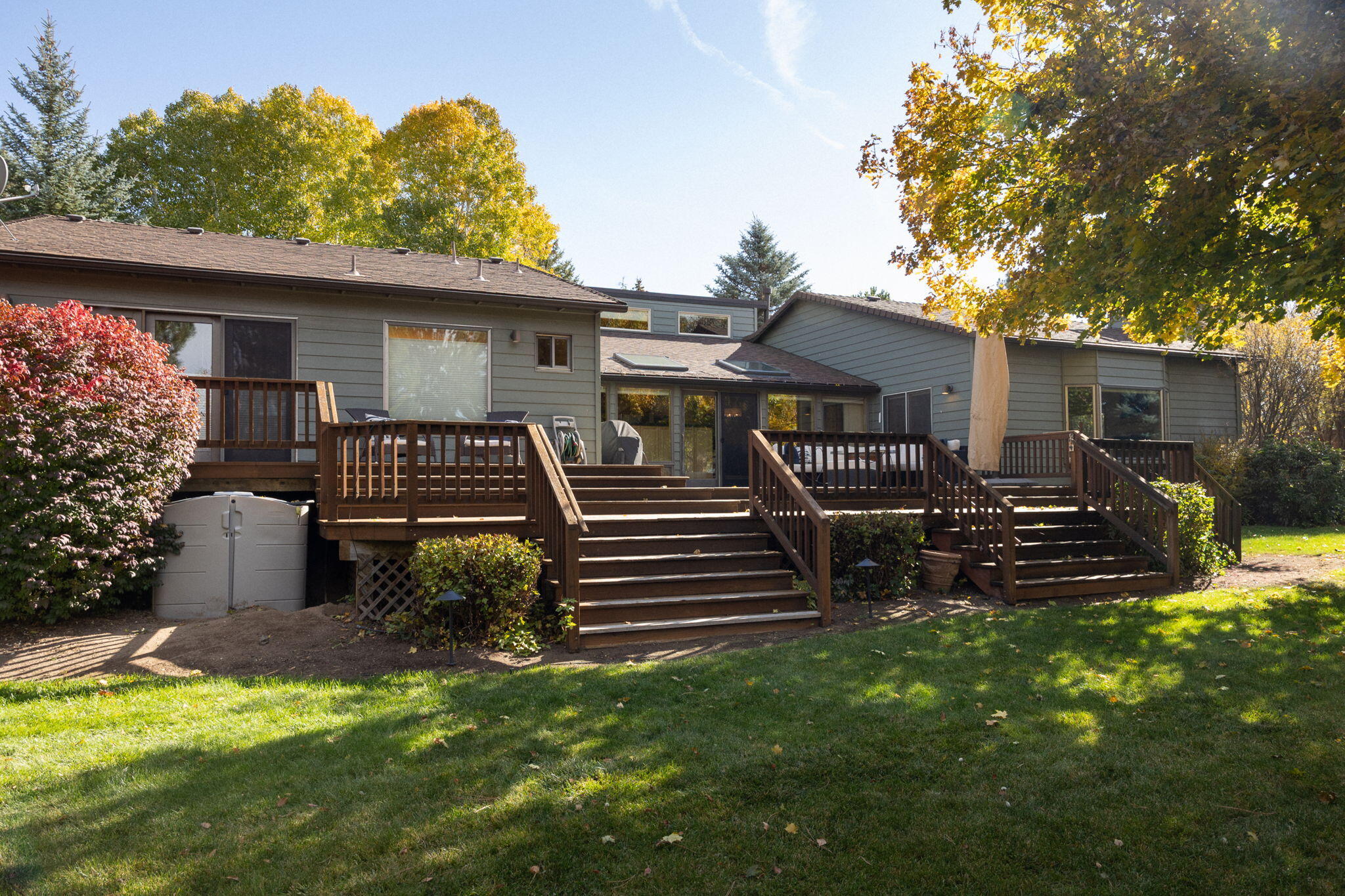 A hidden gem in a prime SE Bend location! Step inside to discover a home filled with warmth, character, and updates. The fully landscaped yard offers a private retreat with mature trees, two storage sheds, and a separate office or creative studio. Enjoy slow mornings or summer barbecues on the spacious deck. Inside, vaulted cedar ceilings, a bay window, oak floors, and classic tile counters create timeless charm. Past remodels added a large family room with a second fireplace and a flexible office or den. Recent upgrades include a remodeled primary bath, new carpet, updated flooring, fresh paint, a newer roof, septic, and exterior paint, plus a new driveway, drainage system, refrigerator, and microwave. Move-in ready and beautifully cared for!