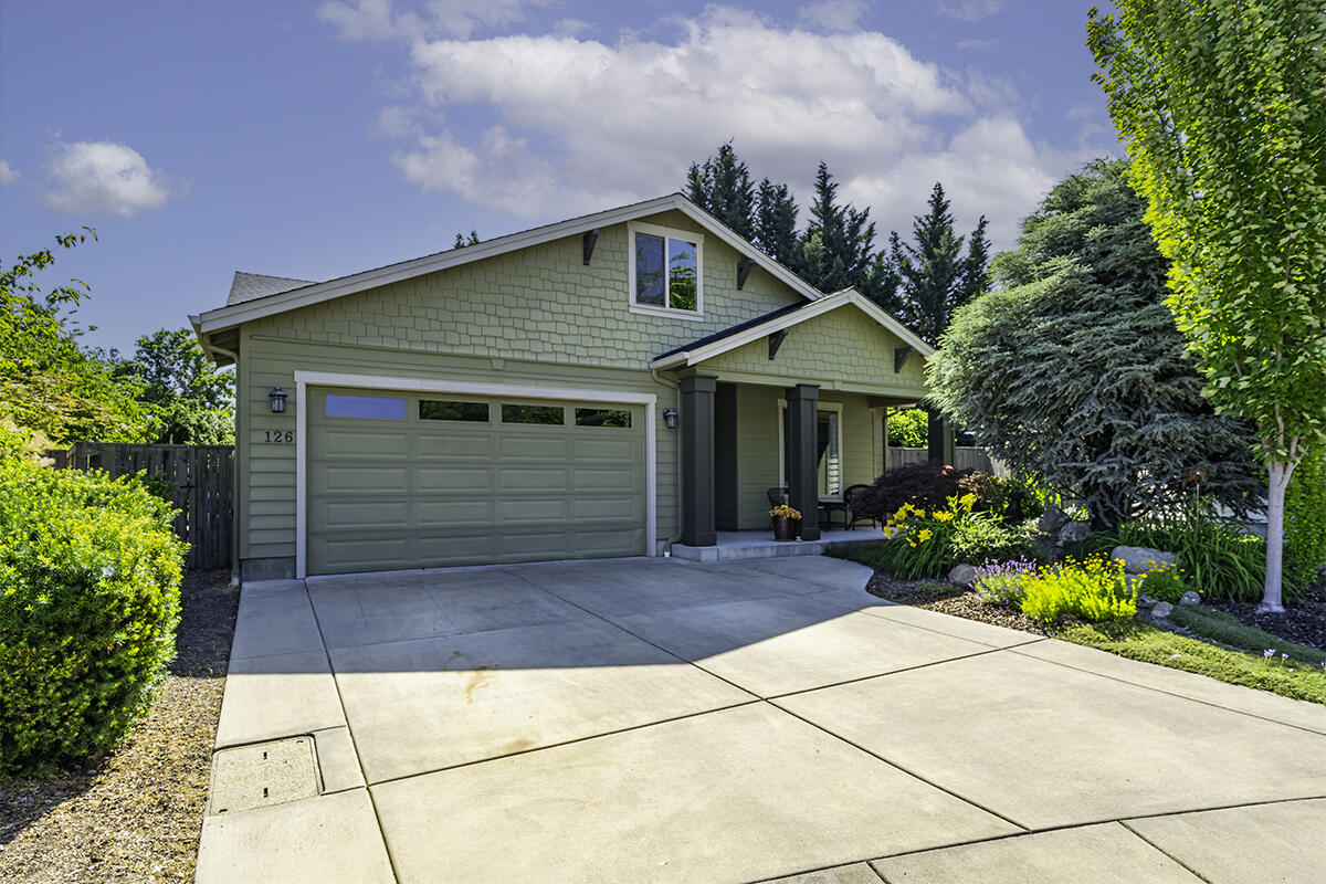 You will love this well-designed single-level built home, tucked away at the end of a quiet cul-de-sac in Talent, Oregon. This quaint & friendly town with eateries, coffee houses & live theater is a favorite of many, located just 4 miles from Ashland.  Built by Cota Homes for a family member, many special features & upgrades added including great room with vaulted ceilings & gas fireplace, smooth porcelain floors & granite kitchen with large dining bar & pantry.  Great split floor plan with lovely primary with upscale Travertine bathroom with dual sinks, stone shower & walk in closet & two additional bedrooms with full bath at opposite end of the home. French doors lead to private, lush rear yard with large, covered patio, second dining patio, mature trees & greenery, fruit orchard, expansive lawn area, planter beds & fully fenced. Nice laundry room with Travertine folding counter, attached garage with workshop area & pull-down storage in the attic. Great neighborhood, fabulous home!