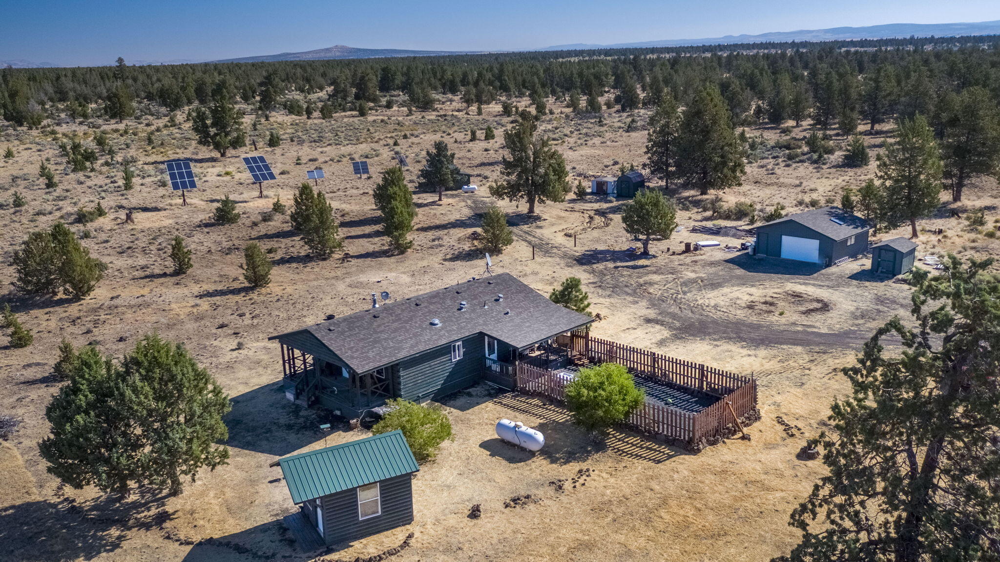 Discover the perfect blend of privacy, nature, and recreational opportunity on this expansive 118-acre flat property, with a home set back from the road offering stunning mountain views and unmatched seclusion. This 3-bedroom, 2-bath residence features a solar-powered system, private well, and garage/outbuildings—ideal for sustainable, self-sufficient living. The property backs up to the Crooked River National Grasslands, with additional grassland access across the road, making it a haven for outdoor enthusiasts. Whether your'e a  nature lover or simply seeking space to roam, this property offers it. Enjoy abundant wildlife, panoramic views, and endless opportunities to explore. Located on the scenic back road to Sisters, OR, and just minutes from boating and water activities at Lake Billy Chinook, you'll have easy access to some of Central Oregon's best recreation while enjoying the peace and privacy of your own retreat.