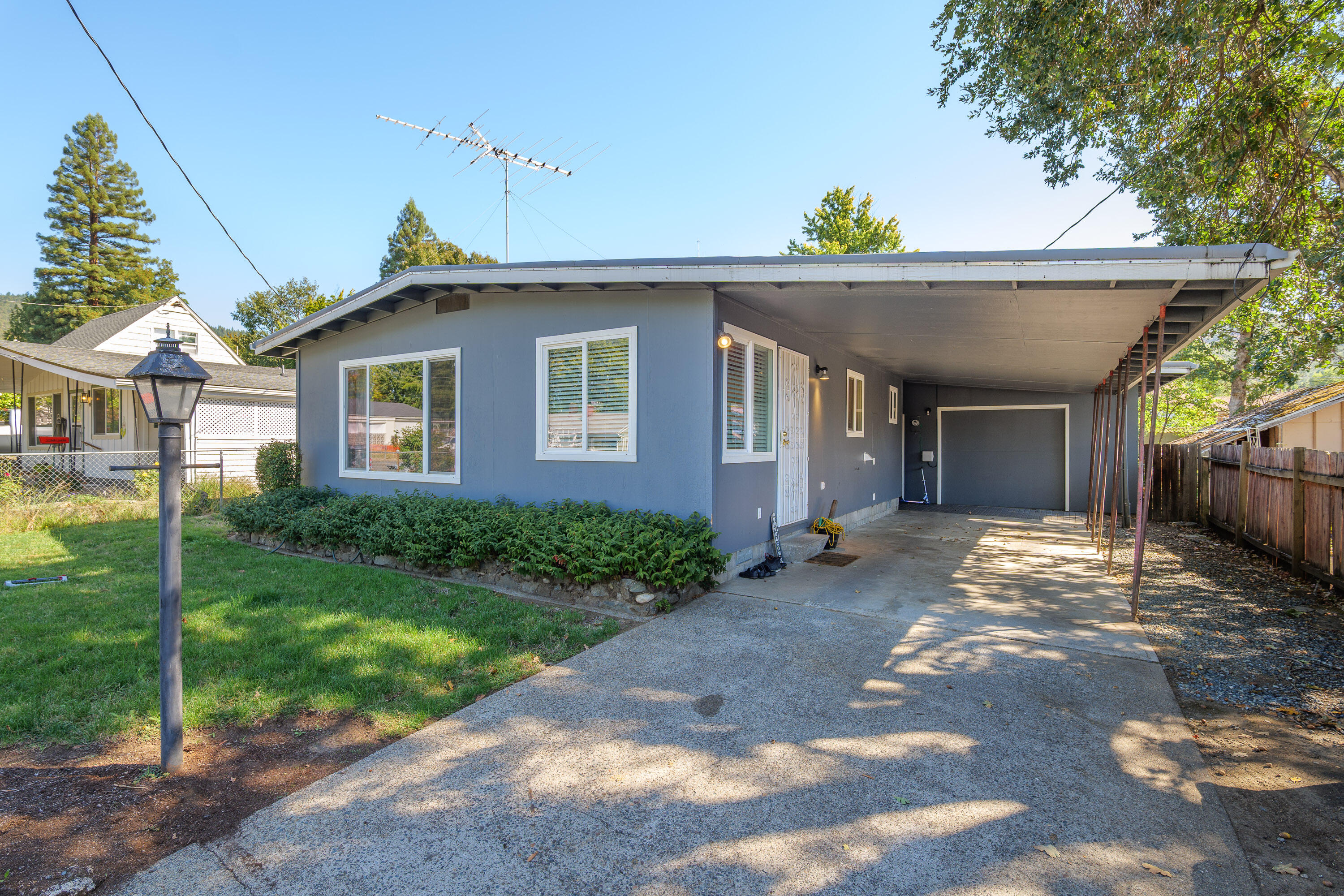 Charming 2-bedroom, 1-bath bungalow tucked into a quiet cul-de-sac with a great in-town location. Recently remodeled, this home offers hardwood floors in the kitchen, a light-filled living room with a cozy fireplace, and two comfortably sized bedrooms. The covered back porch is perfect for morning coffee or evening relaxation, overlooking a private backyard with established fruit trees. An oversized detached garage/shop provides plenty of space for hobbies, storage, or projects, while the one-car carport and gated entry add convenience and security. Whether you're looking for your first home, downsizing, or an investment property, this bungalow combines character, functionality, and easy access to schools, shopping, and medical facilities. Seller is Licensed Real Estate Broker