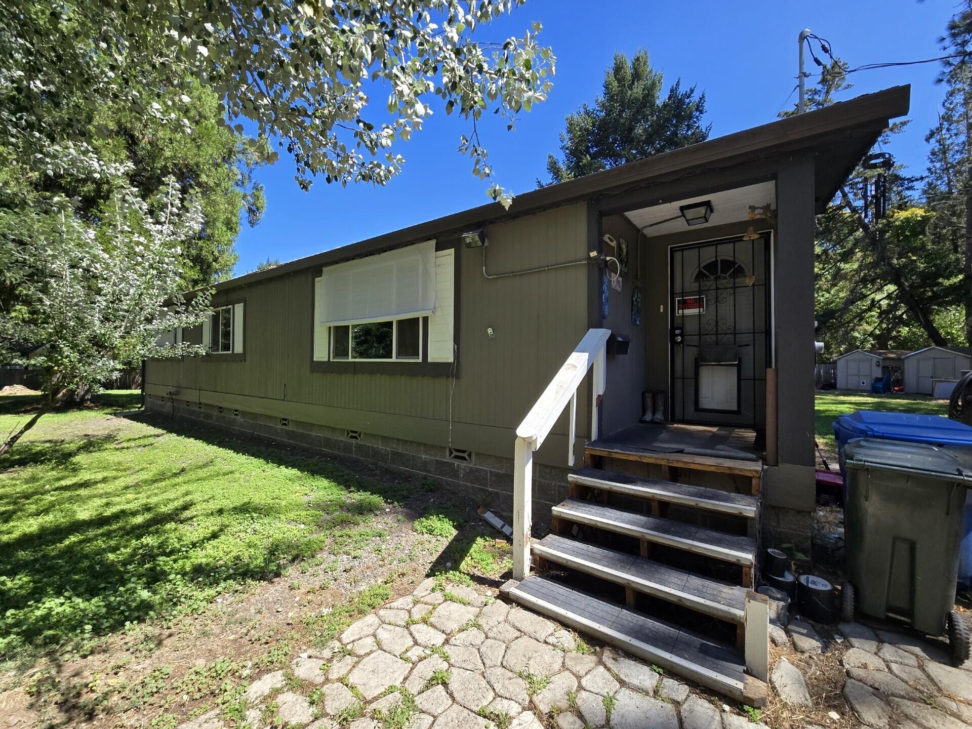 Nice Country Home situated on .87 acres fully fenced, located within walking distance of the Beautiful Rogue River and located halfway between Grants Pass and Rogue River.  This clean 3-bedroom, 2-bathroom 1404 SqFt. Marlette Manufactured home features vaulted ceilings, updated kitchen w/stainless steel appliances, hickory cabinets & farm sink, lots of storage, vinyl double-paned windows, & updated vanities.  Enjoy the level fenced yard with storage sheds, Covered RV parking with full hook-ups and another carport, paved driveway and GPID irrigation, 8GPM well (per-seller) with 1500 Gallon holding tank. Don't miss out on this one!