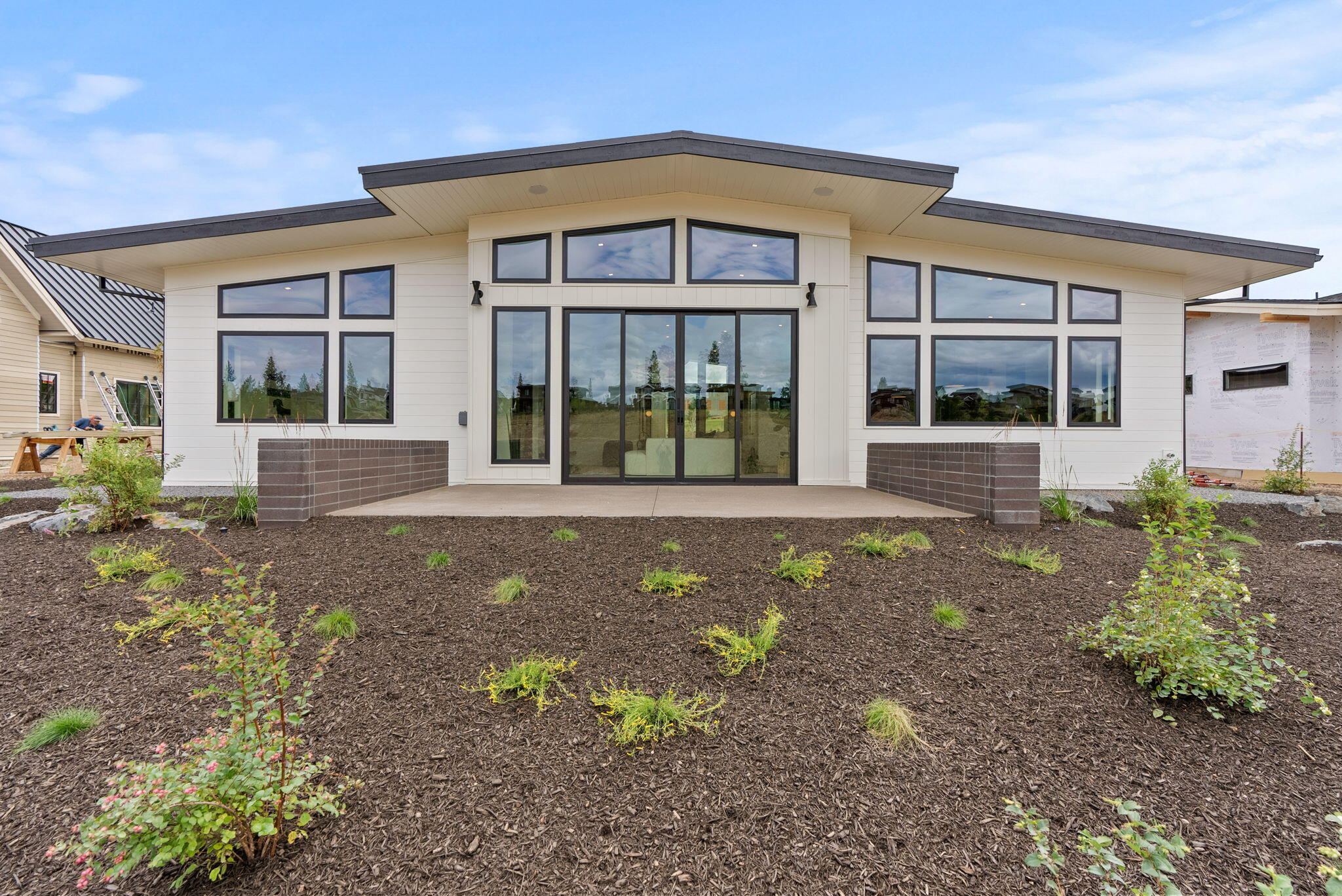 Truly an incredible value. Single-level, mid-century modern stunner in Discovery West built by BendTrend Homes. The home was designed to seemlessly blend nature, quality, and accessibility in a space that is functional yet sophisticated. The vaulted plan sprawls 3,172 sf and boasts 4 beds, 4 baths, a den and 3-car garage with an RV/sprinter bay. This home shines with its rich and refined materials that complement our high desert surroundings such as custom walnut cabinets, white oak floors, matte black fixtures, quartz counters and brick fireplace. You'll enjoy radiant heat in a spa-like primary bath, AC to cool the warm days and a private patio equipped for your fire pit, BBQ and hot tub. Glass sliders open over the Discovery Park trail system which, in moments, will have you biking on Phil's Trail, sipping coffee at Discovery Corner or letting your pups play off-leash at the park. Live easy in this beautifully crafted home accessible to so much of why we love to call Bend home!