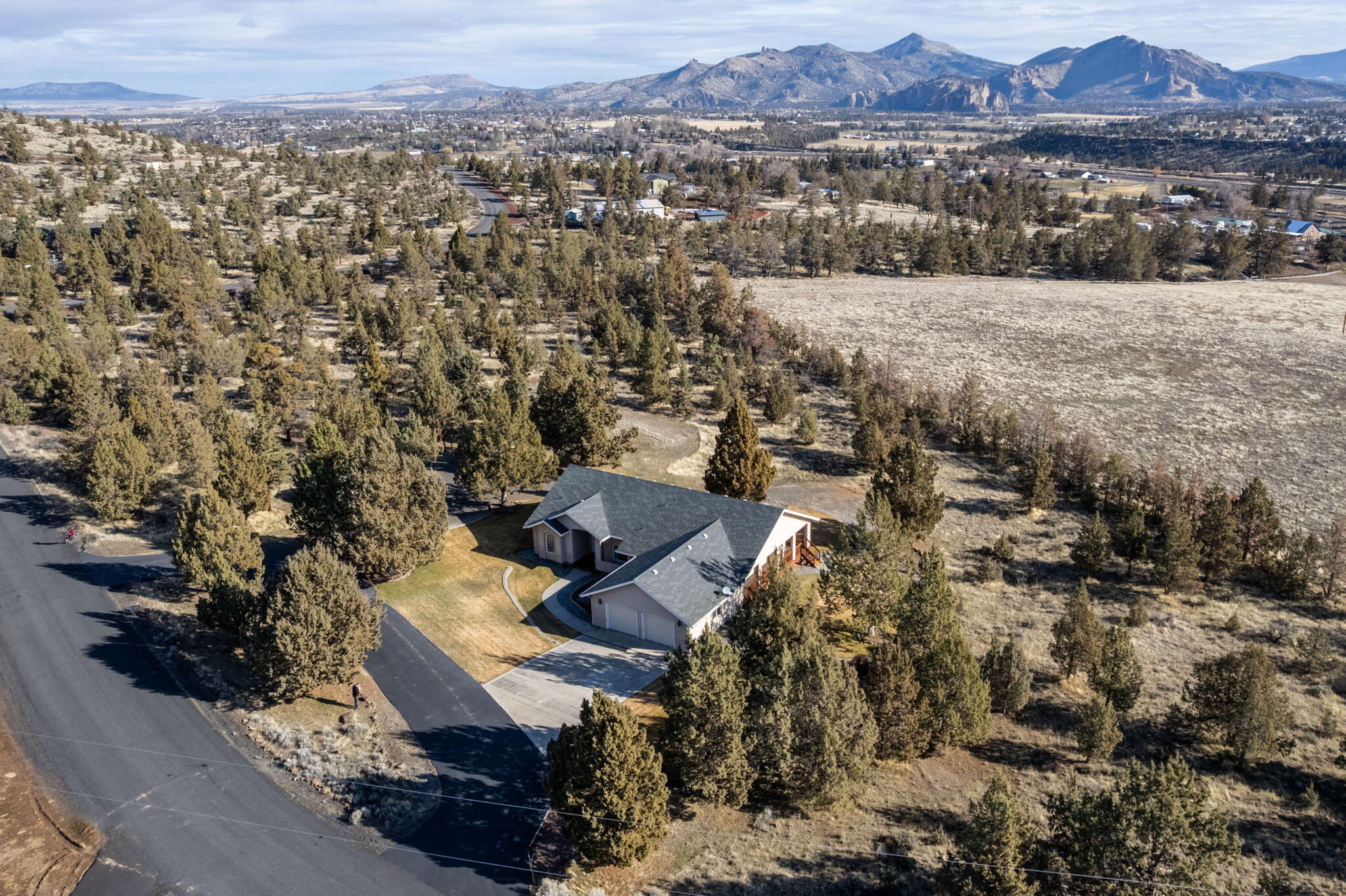 Custom built home in Terrebonne on 6.5 acres. The single level home lives larger then it's approximately 2,000 square feet. The primary suite in one side of the house while the other 2 bedrooms and a bathroom are on the other side. When you come into the open entry, you are greeted with a formal living and dining room. Then move on to the large kitchen which opens into a family room, and breakfast area. There are beautiful cherry wood cabinets throughout and solid surface countertops in the kitchen. Avery nice propane fireplace is in the family room. The 2 car garage has plenty of room for all your toys or projects. There is a covered deck that goes the whole width of the back of the house and down the side. It's great for relaxing and enjoying the beautiful landscaping. Great views of the mountains towards the east. The circular driveway is paved to the street. Lots of privacy.