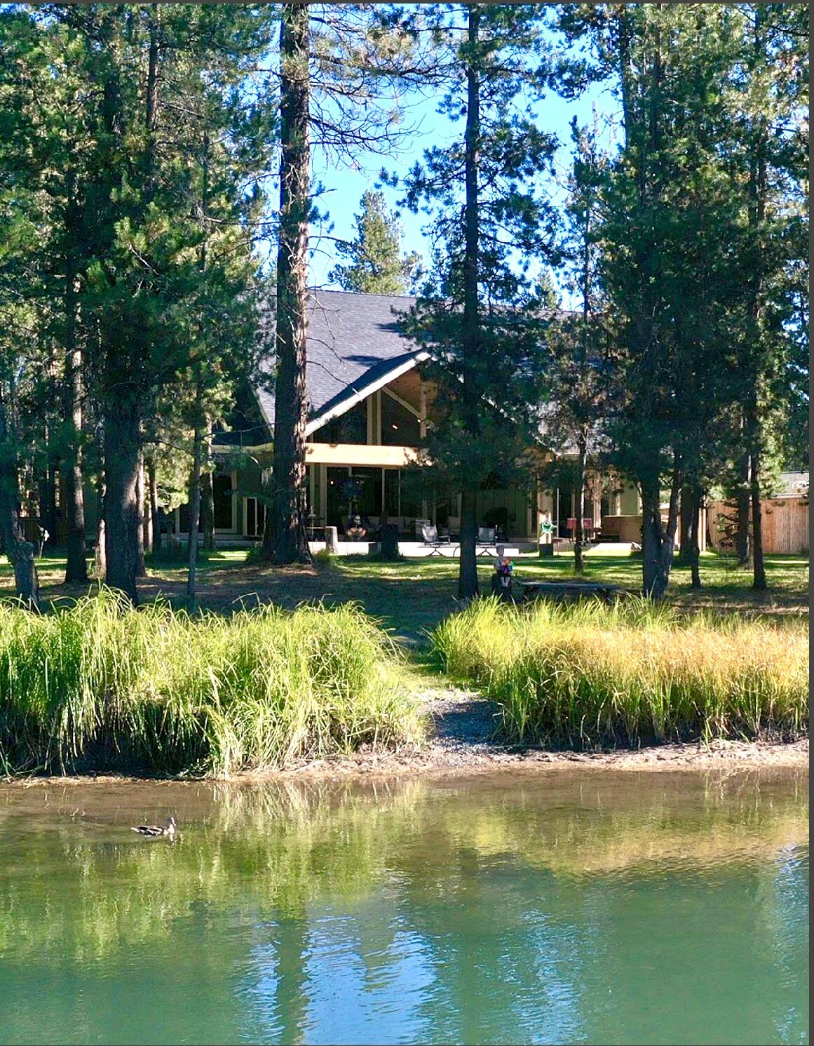 Come see this beautiful custom built home nestled along 125 feet of private access to the Big Deschutes River. This home features 3 bedrooms and 3 full bathrooms, in addition to an extra office space and upstairs loft with a breathtaking view of the river. Enjoy over 1000 square feet of covered porch while relaxing in your own backyard oasis.  Included with the home comes 1090 square feet of garage space with the ability for RV parking and ample storage. RV hookups and sewer dump are on site as well as fully landscaped front and back yard with multi zone heating and cooling system accessed from your cell phone. BONUS this home is in the county making it available for a  short term vacation rental. Welcome Home!