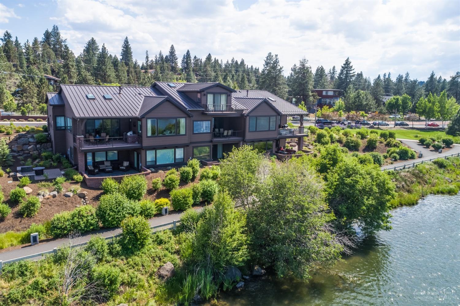 Set on the banks of the Deschutes river & a few steps from the Old Mill District, you'll find an exquisite luxury townhome among Bend's prized outdoor playground! Approx 3156 sqft, Master suite on main, w/3 bedrooms, 3 1/2 baths & bonus room. Technology abounds w/Control 4 system managing the house (lights,temperature, blinds, doors, sound, TV, fireplace, etc). Gourmet kitchen w/SS appliances, quartz counters& wd flrs. Covered deck w/infrared heater, sun shade & builtin BBQ.River & Mtn views. Sold furnished