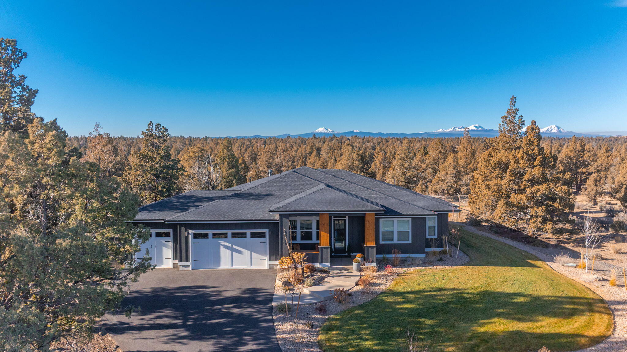 Welcome to this beautiful, three-year-old home nestled on almost ten acres. Featuring four spacious bedrooms plus an office, three full bathrooms, and a Jack and Jill bathroom for guests. Enjoy breathtaking Cascade Mountain views and the privacy that comes with backing up to hundreds of acres of public lands, which include miles of walking trails. The property also features new landscaping with irrigation, a small animal corral or garden area, and a large lawn area perfect for kids. Additional features include a 30x42-foot shop with power, a 32x62-foot enclosed sport court featuring Cushion Court technology, and a three-car garage. The beautiful covered patio with tongue and groove detailing completes the perfect setting for relaxation and entertainment.