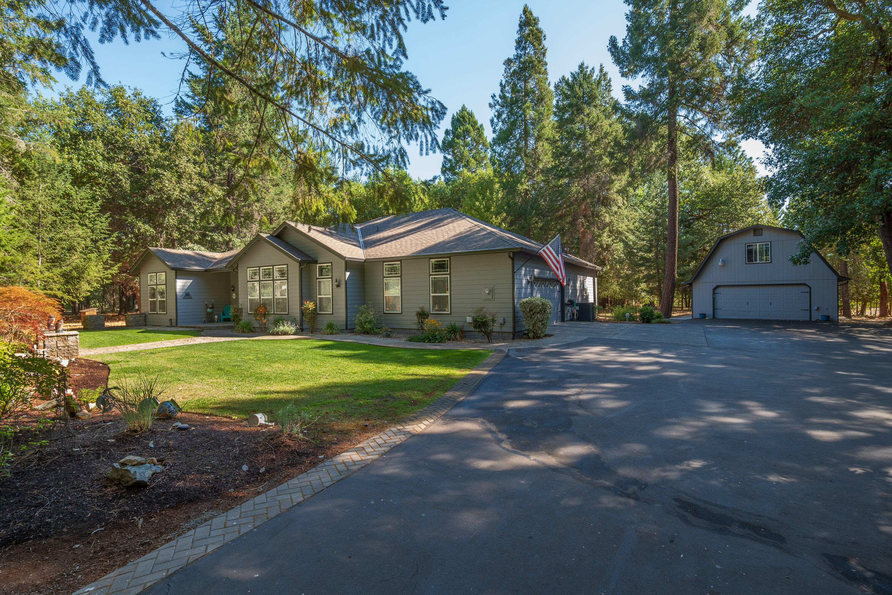 Country living awaits on 2.22 fully fenced acres featuring a single-level home, shop, and furnished ADU tucked away on a quiet cul-de-sac! The 2,267 sq. ft. main home is thoughtfully designed with a split floorplan, 3 bedrooms, and 2 bathrooms—perfect for both privacy and entertaining. A grand entry welcomes you with 10-foot ceilings, transom windows, and elegant columns. The primary suite flows seamlessly to a covered back porch, ideal for morning coffee or peaceful evenings surrounded by nature. An oversized attached garage plus a detached 768 sq. ft. shop provide room for hobbies, storage, and all your toys. Above the shop, a 425 sq. ft. fully furnished ADU adds versatility for guests, rental income, or multi-generational living. Make this Southern Oregon Home yours —call today for a tour!