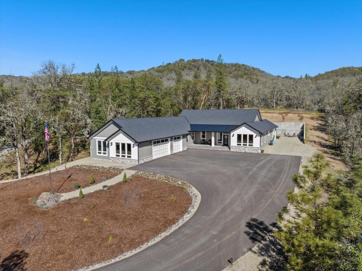 Welcome to one of the most private luxury properties on the market! Located on Old Stage Rd in Central Point. As you drive through the gated entrance, you follow the fully paved driveway up to the home. Situated on 5 acres of useable land, backing 40 acres of BLM. This newer single-story custom-built home has a split floor plan & open layout concept. With 3,000+ sqft, 3 beds, 2.5 baths featuring real hardwood floors throughout the entire residence, along with impressive 11 ft coffered ceilings. The kitchen is an entertainer's dream with an oversized island, complemented by all-wood cabinets and newer stainless steel / glass appliances. The primary bedroom has vaulted ceilings, smart under-lighting in the hallway, and a massive walk-in closet. The primary bathroom boasts a soaking tub with views, double vanities, and an extra large walk-in tile shower. 50 year roof, energy star qualified zoned heating & cooling system, fully permitted shop location, & 2 Full RV Hookup spots!