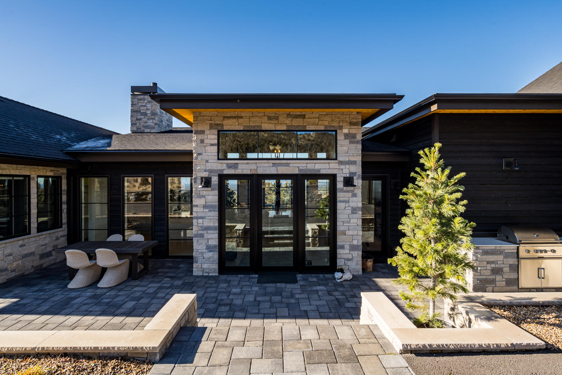 Welcome to this extraordinary luxury single-level home, built in 2023 in the prestigious Brasada Ranch Resort. Meticulously designed, this home offers a harmonious blend of contemporary modern style and timeless comfort. Every detail has been thoughtfully curated to provide the ultimate living experience. Upon entering, you'll be greeted by a spacious open-concept floor plan and high ceilings that seamlessly connect the elegantly designed living and dining areas. The heart of the home is the gourmet kitchen, featuring custom walnut cabinetry, quartz countertops, top-of-the-line Thermador appliances, and a well-appointed walk-in pantry. The great room opens onto a spacious deck with breathtaking views of the Cascade Mountains - perfect for entertaining or relaxing. Expansive picture windows flood every room with natural light, creating a bright and airy ambiance. The primary suite features a cozy fireplace and a spa-inspired en-suite bathroom with modern fixtures and finishes.