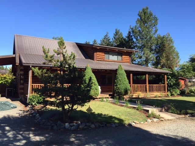 This beautiful custom log home offers all the warmth that is brought to mind when you think of a log home. This home has it all, Granite counters, wood, carpet and travertine floors as well as many other upgrades throughout. Set on nearly an acre of flat beautifully landscaped property with an in-ground sprinkler system, green house, gazebo and wrap around covered deck with outdoor kitchen all nestled between Jacksonville, Medford and Ashland. Healthcare, shopping and cultural events are all close by. This turn key home, shows pride of ownership and is ready to move in. Recently refinished, the fences, shop and home shows like new. Two Complete RV hook ups make it convenient for guests. One set of hook ups inside the 44 X 18 RV Garage and one outside. A large 30 X 32 shop with 200 Amp service is located next to the RV Garage and large parking area for boats, trailers and any other parking. 20 gpm when drilled