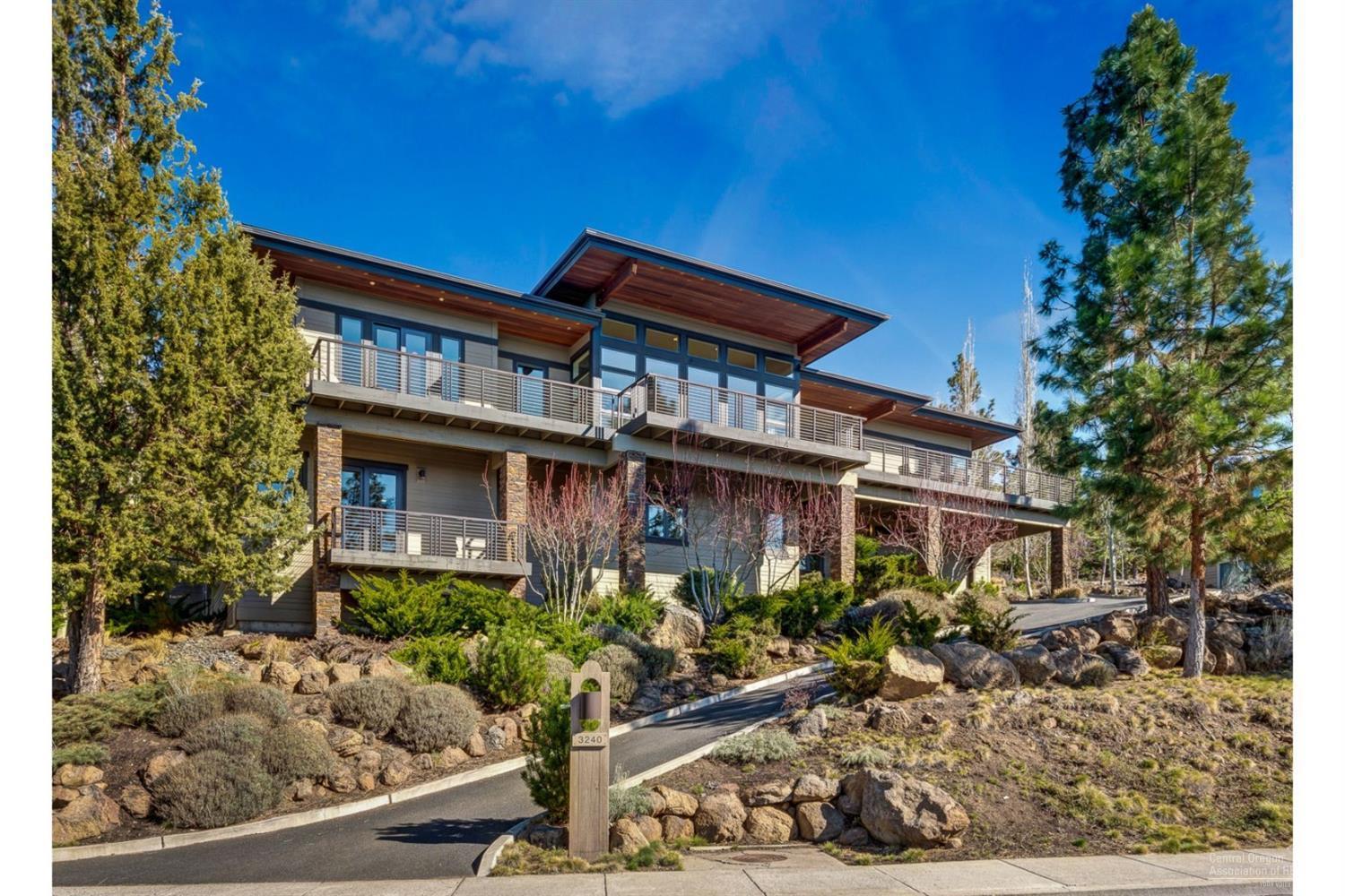 Modern luxury w/ views in every direction atop Awbrey Butte. Home features (2) expansive levels of living. Main level w/ (2) master suites, great room w/ walls of windows & Cascade mtn views. Gourmet kitchen w/ high end appliances, formal office, den, & heated oversized (2) car garage. Downstairs finds another living area (2) bedrooms, separate utility, abundant storage, & oversized (2-3) car garage. Extensive decking, and private courtyard for entertaining & enjoying the wood fireplace!