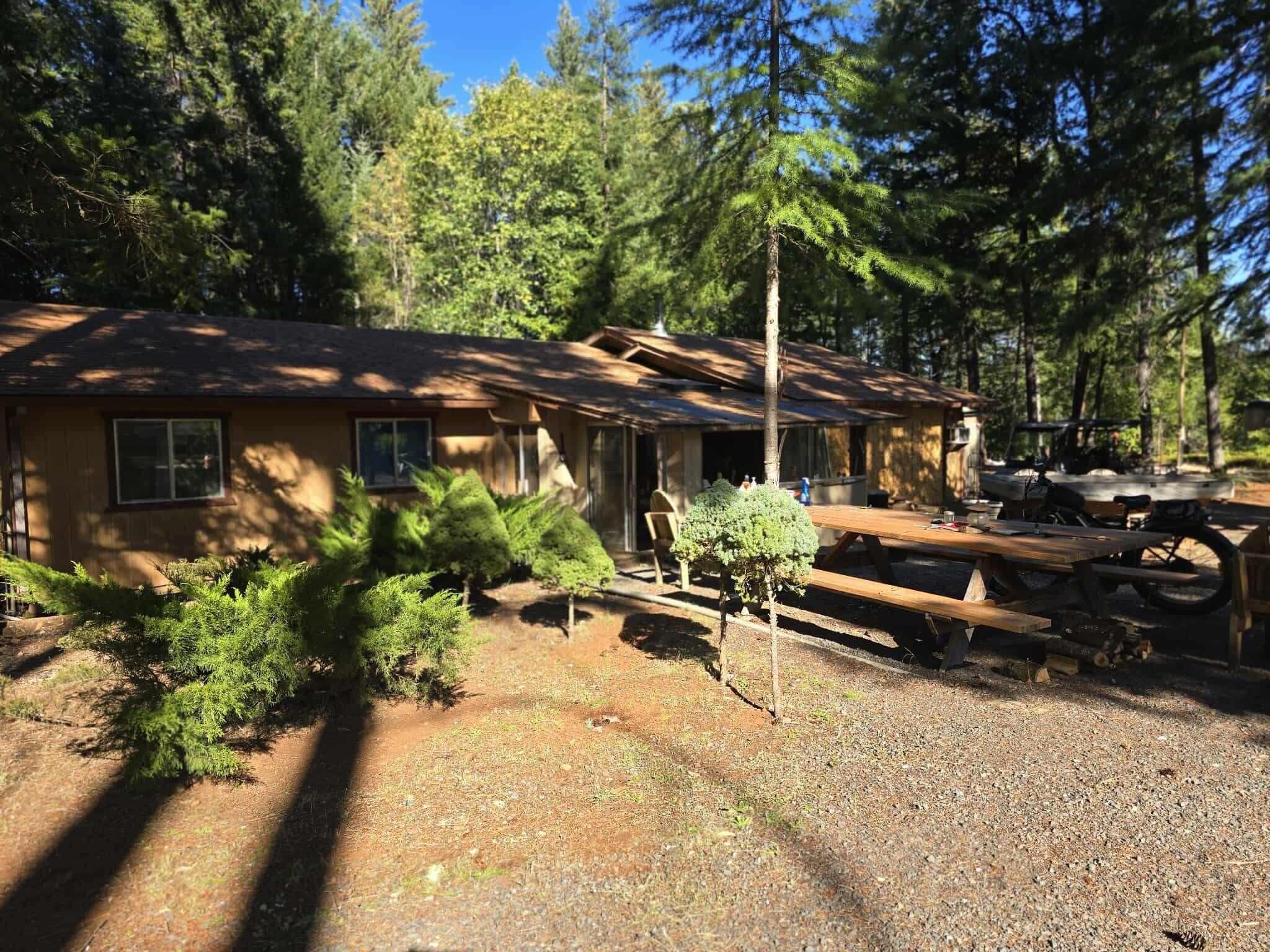 Peaceful Country Living on 5.04 Treed Acres!
Tucked away in a beautiful, park-like setting, this charming 1978 ranch-style home offers privacy and comfort on 5.04 acres of mature trees and open space. The home features 3 bedrooms and 2 bath, a circular driveway, and a covered back patio overlooking the chain-link fenced yard.

Enjoy the outdoors with fruit trees, a garden area, RV hook-up. The property also includes a large shop—perfect for projects or extra storage— impressive 50 GPM (per well log).