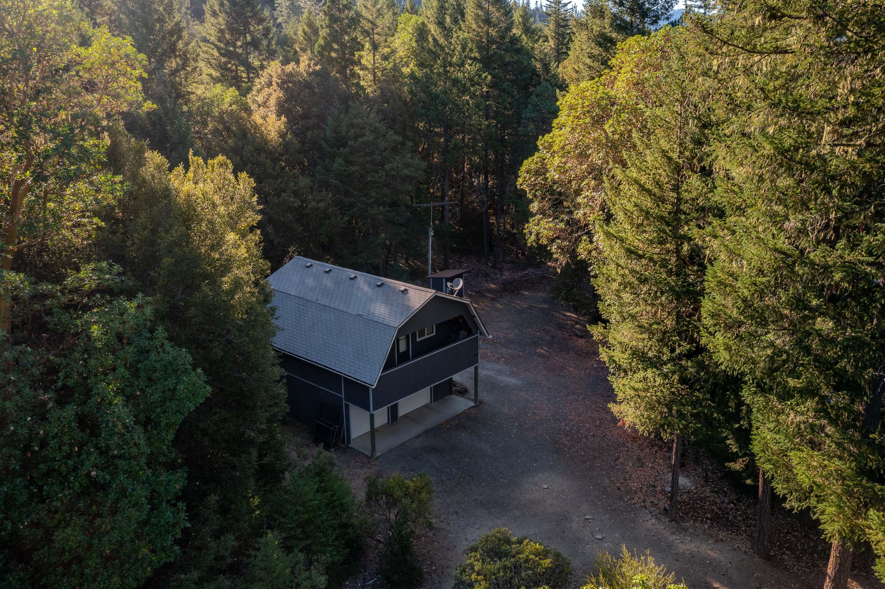 A true outdoorsman's retreat—this rare 7.36-acre parcel backs to thousands of acres of federal land, offering unmatched privacy and direct access to wild country. Towering old-growth timber, massive boulders, and a peaceful forest setting give this property a unique and rugged charm. Whether you're into hunting, hiking, or just looking for solitude in nature, this is the kind of place that's getting harder and harder to find. The 1-bedroom cabin-style home, built in 1997 above a two-car garage, is cozy, solid, and full of character—ideal as a full-time residence or a landing spot while you design your dream build. Private well with a newer pump (installed within the last 5 years), RV hookups, and BLM on two sides—this one stands out.