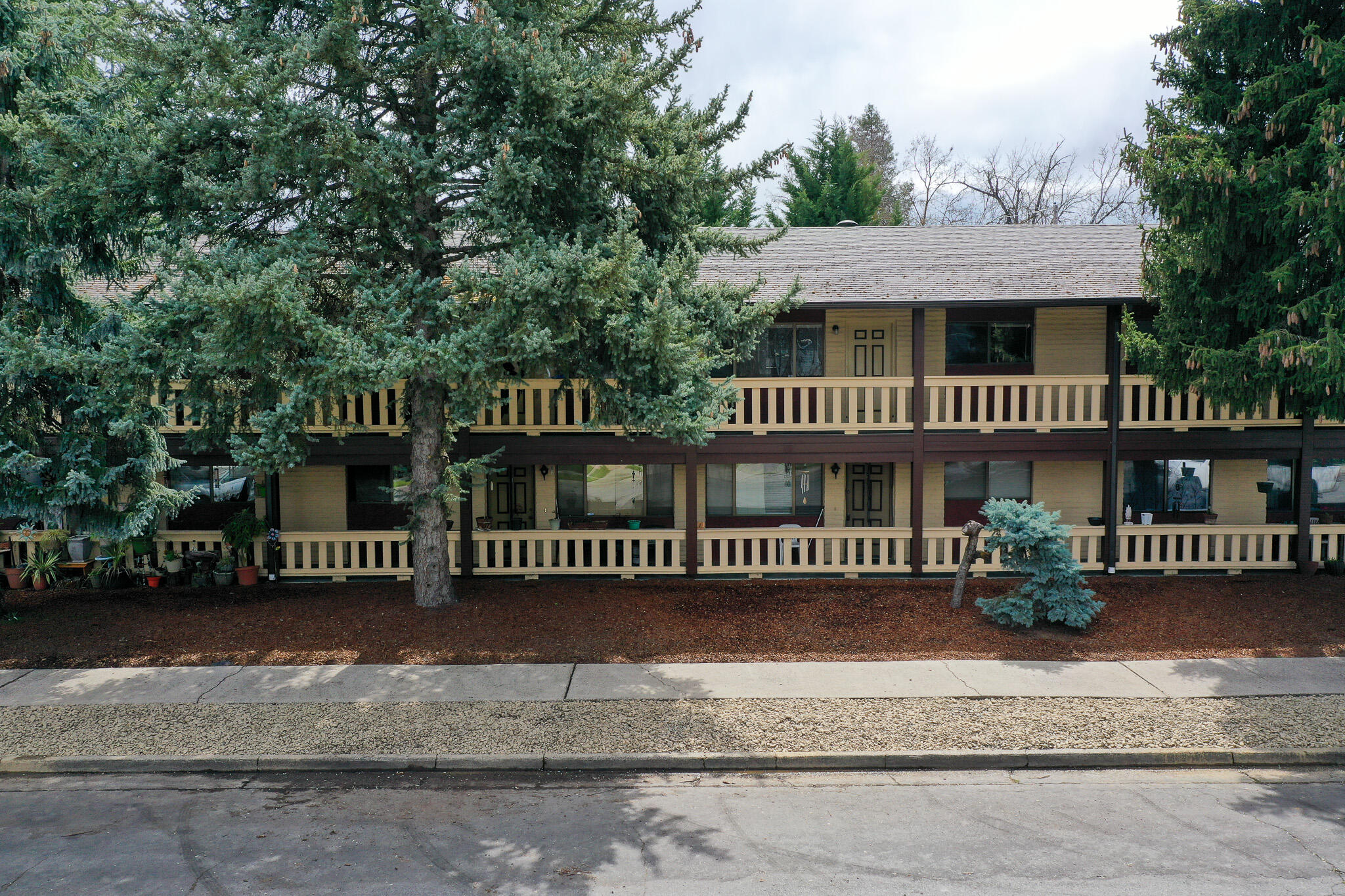 First time on the market for this well cared for 7 unit apartment complex in the heart of Grants Pass.  Built in 1977 with 6,996 total square feet on .34 acres, the property has been perfect to create long term tenants. There are 3 two bedroom one bath units upstairs & 3 two bedroom one bath units downstairs.  One unit has 3 bedrooms and 2 bathrooms with one bedroom on the main level and two bedrooms upstairs.  Each unit has their own washer/dryer hookups and includes range/oven and refrigerator.  Some units have updated vinyl in the kitchen and updated carpet in the main living areas and bedrooms. Close to downtown Historic downtown Grants Pass with lots of dining, historic buildings, and shops.  Less than 2 miles from I-5, Three Rivers Community Hospital, Home Depot, Walmart & schools.  Plenty of tenant parking in the parking lot and on the street.