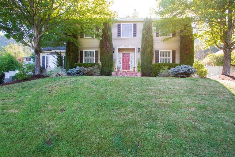 Hard-to-find Colonial-style charmer gazes over the NE end of city. 2756 s/f with 4 BR/2.5 BA, w/additional 900 s/f basement w/ exercise area and abundance of shelves/cabinets. All this on a double city lot which allows room to play and everything you need to entertain. Elegantly remodeled, there's a spacious living room w/gas fireplace, formal dining room and a stunning kitchen filled w/ granite counters, state of the art appliances behind custom cabinets and an island with seating for 4. Also a bar area with wine cooling refrigerator. Huge family room is warm and inviting with beamed ceilings, a used brick hearth and a 2nd gas fireplace. Upstairs, a master bedroom suite to delight the senses...a glorious bath with marble floors/counters, huge walk-in shower, soaking tub and vanity. The closet is equipped with built-in washer/dryer, and organized beyond your dreams. Step into the backyard, w/ party-sized covered patio for outdoor dining & water feature under canopy of mature trees.