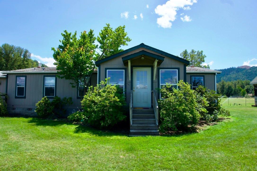 2 legal & separate 5 acre parcels w/ existing homes for a total of 10 acres with Applegate River water rights. 2 family setup! 3 bedroom 2 bath manufactured w/2 car attached garage, w/rear deck overlooking pastures & 200x100 outdoor arena. Multiple outbuildings include 28x70 packing shed w/3 levels & new roof in 05' w/finished room & power, 16x60 5 bay equipment shed, 6 stall noble barn & wash rack & tack room. Pasture includes underground irrigation system & fenced garden on sprinklers fully fenced and cross fenced with no climb. This property is turn key as a horse/cattle property and room to farm with captivating views of the surrounding mountains. Older singlewide located at 3626 Helms as a 2nd legal parcel/dwelling in need of TLC. Seller may sell 5 acre parcels individually subject to removing partial encroaching barn located on 3626 address or lot line adjustment. All information deemed reliable, but not guaranteed.