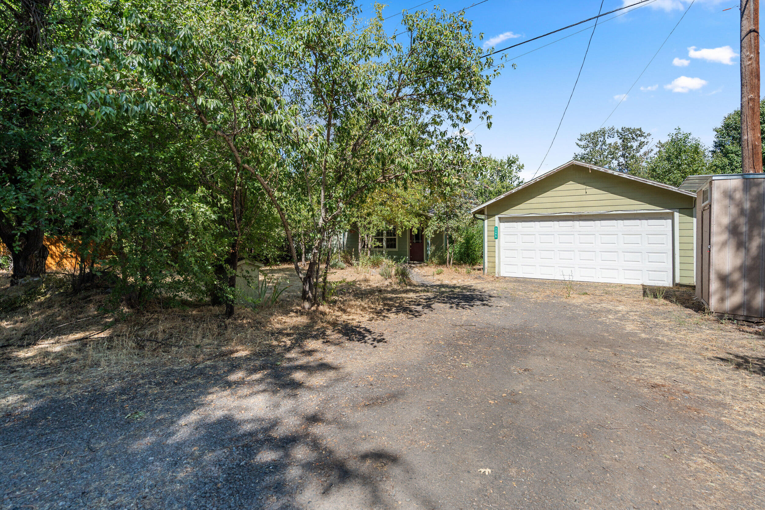 Beautiful setting! Listen to year round Neil Creek from your outdoor sauna! 2310 SF provides lots of space including  a living room, a family room, 3 bedrooms and some bonus rooms all on nearly a half an acre. Hardwood floors, cement board siding, covered back deck. The golf course is just across the street. Minutes to town but country setting. Ready for your vision. See Instructions.