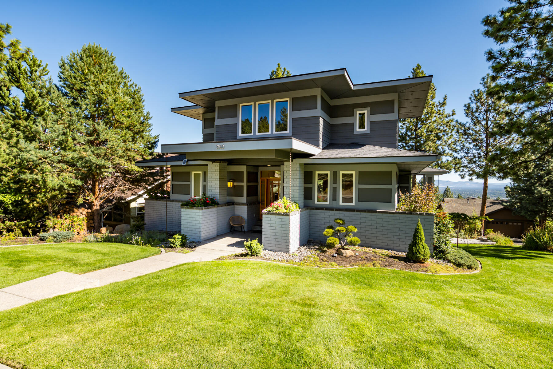 Experience all that Bend has to offer from this beautifully crafted Prairie style home ideally located in the Awbrey Village neighborhood in NW Bend. This quality built Leader Builders home features an open floor plan, elegant living spaces and extensive recent upgrades along with an abundance of windows that flood the home with natural light and capture impressive easterly mountain views. The main level primary is complete with coved ceiling and spa-like bath with dual vanities, soaking tub and well equipped walk-in closet. A second bedroom, full bath and generous laundry room complete the main level. The upper level offers a spacious bonus room with built-in tv and fireplace, a comfortable third bedroom with walk-in closet and a well appointed full bath. An oversized extra deep garage has space for adventure gear plus extended storage under the home. Close to community park and trail access to the Archie Briggs Canyon and trails beyond, this is a wonderful base camp for Bend living!