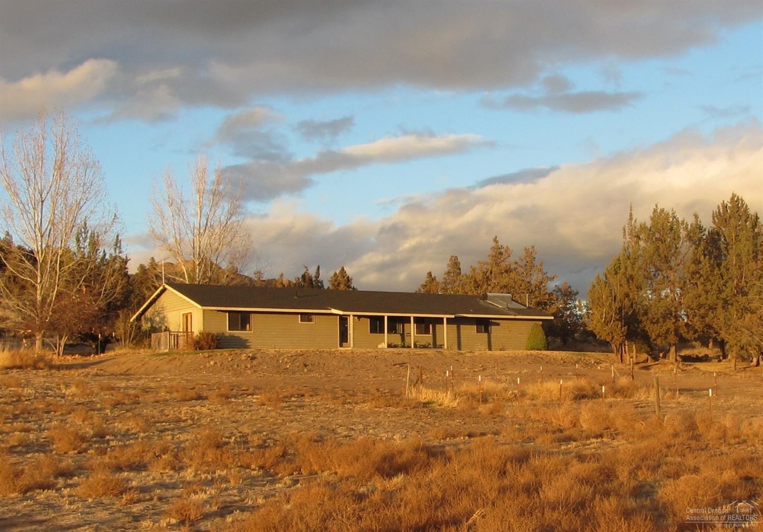 Single-level classic rancher on 5 acres. Situated in lovely quiet treed neighborhood of stick-built homes with paved roads. Spacious floor plan ready for you to make it your own changes. Kitchen-dining area overlooks the rolling hills for lovely views. Covered front porch, and wood decks off living room & master with french doors. Spacious rooms throughout, walk-in closets in each bedroom. Separate utility room between kitchen & garage. Attached double garage provides covered parking. Picturesque setting located close to town, and served by well water. Room for animals, garden, RV parking. Won't last, call now!