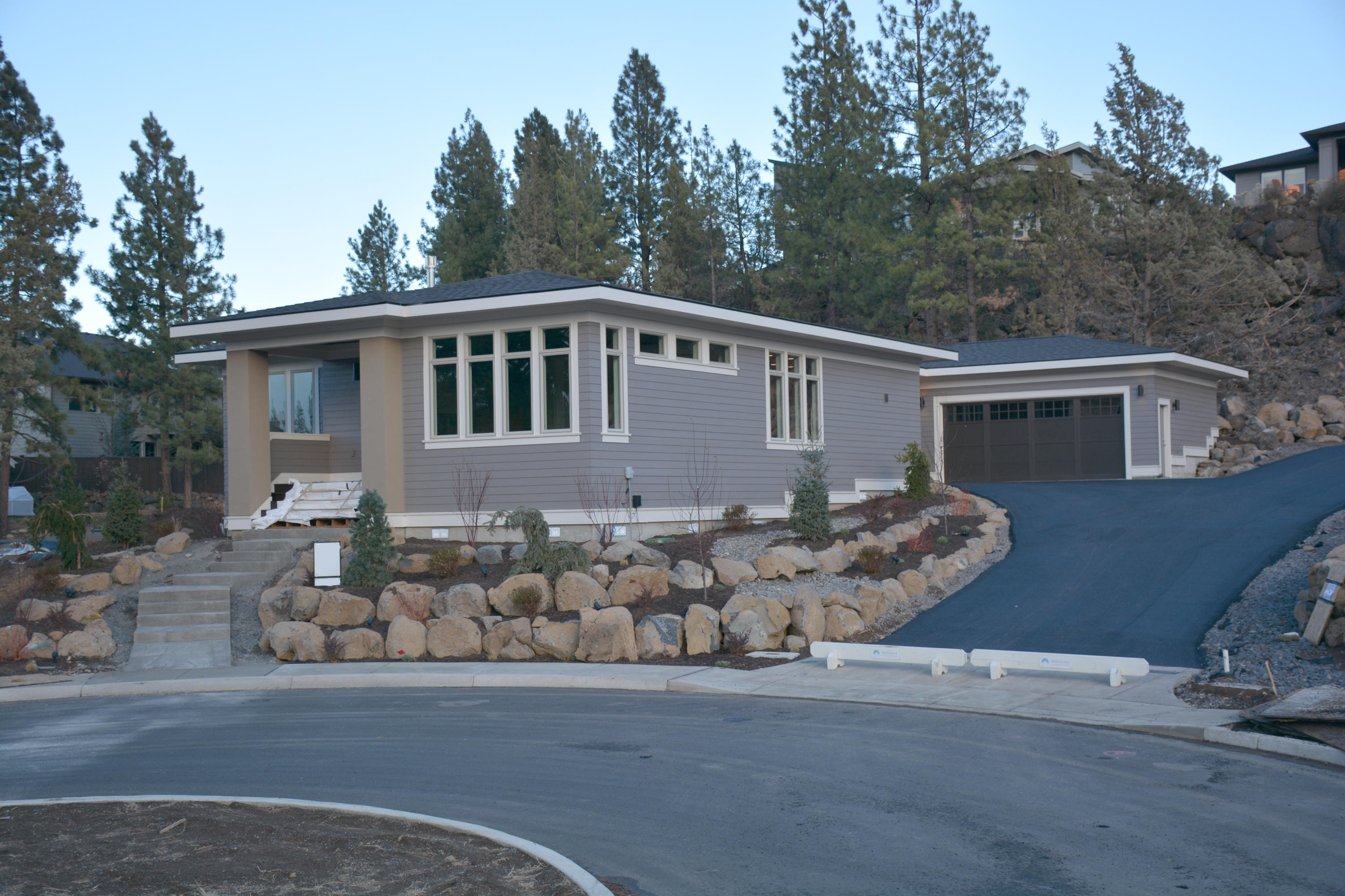 Under Construction. Estimated completion December 2020.  Built by Skylight Homebuilders. Award winning homes. 2019 Tour of Homes, best of show, best interior, best kitchen, best value. Great location near miles of walking/biking paths at Shevlin Park and close proximity of Northwest Crossing. This is one of the finest lots in Shevlin Bluffs, 12,000+ est. sq. ft. lot with mature firs, amazing rock bluffs, cul-de-sac location. Only 6 lots on street. Single Level 2435 sq ft Prairie Style home, 3 bedrooms, 3 baths. 10 foot tall walls. 8 foot doors. Spacious floor plan, 2 car oversized garage. Stained wood beams in family room, master bedroom opens onto private covered patio. Cabinets will be Grey stained Rift Oak, master bath features Toto wall hung Toilet with washlet, tub and shower. See the virtual tour or movie to preview.