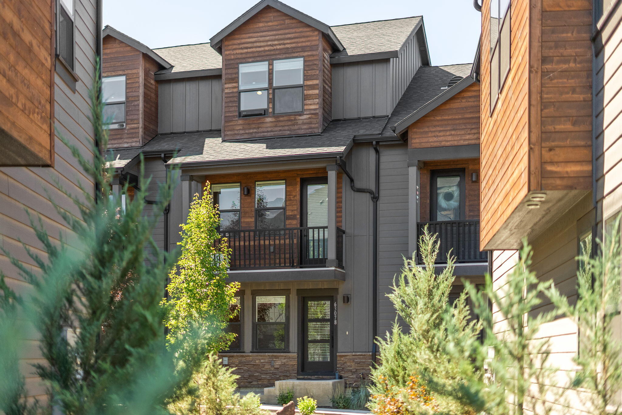 Experience elevated living in the heart of Bend with this beautifully designed mountain modern luxury townhome. Featuring an award-winning blend of architecture & craftsmanship, this is the largest layout available—offering spacious, flexible living across 3 thoughtfully designed levels. Enjoy the convenience of a main-level primary suite complete with bath & walk-in closet. The second floor showcases a stunning great room concept—perfect for entertaining—alongside a guest bedroom and full bath. The third level offers a second luxurious suite with its own en suite & generous walk-in closet, providing ideal separation of space.
Enjoy high-end finishes including warm wood floors, quartz countertops and wood accent walls. A fully finished two-car garage adds functionality & storage. Situated in a prime location close to Bend's best recreation, dining &shopping, this home is designed to enjoy the CO lifestyle!