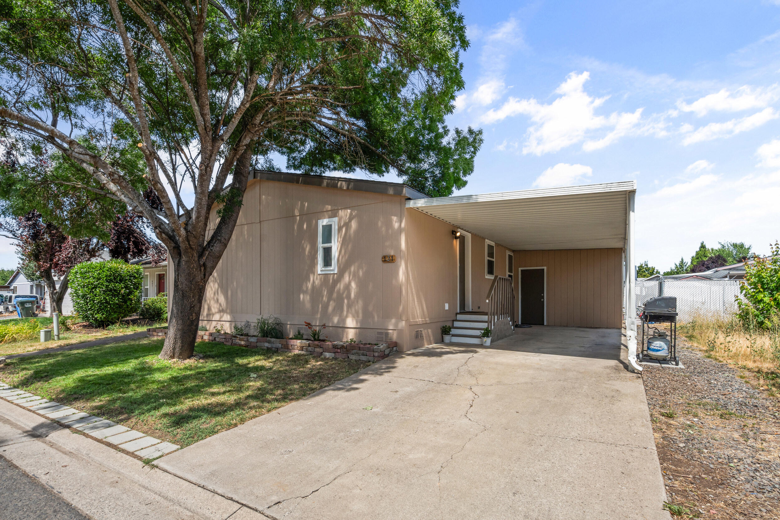 Amazing opportunity to own a beautifully updated 3 bed, 2 bath manufactured home in the desirable Butte Crest community. Home features new windows, fresh interior paint, updated doors, remodeled kitchen, and is move-in ready. Spacious primary suite includes an ensuite bathroom. Enjoy outdoor living with a large covered back deck perfect for relaxing, a fully fenced yard with room for a garden, and a generous storage shed. Covered carport provides convenient parking. Don't miss this charming and affordable home!