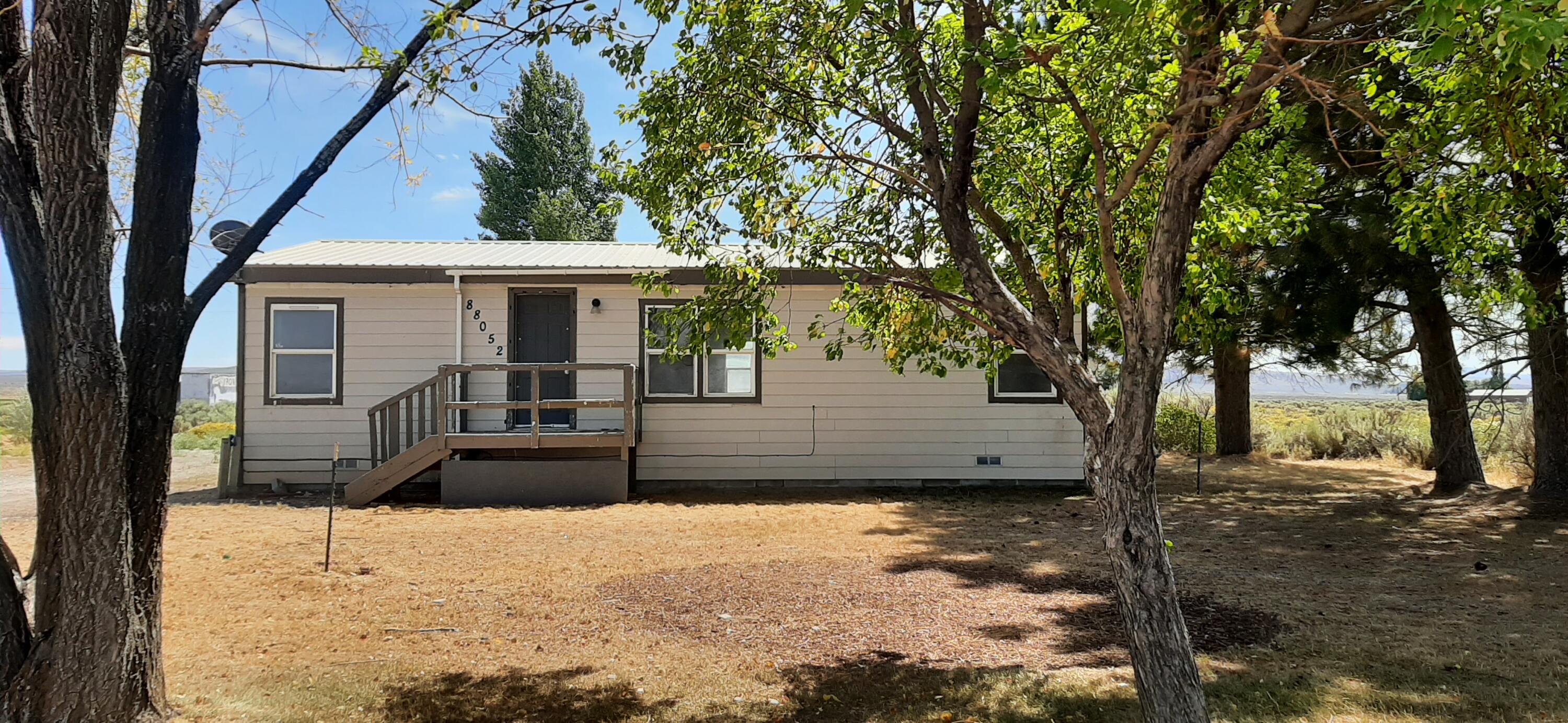 Charming 2 bedroom, 2 bathroom home located on two dividable 1-acre parcels in Christmas Valley. This well-built home features new carpet and laminate, generous storage, and a large bonus room with potential for conversion into a third bedroom or flexible living space. Topped off with a metal roof. The property includes a tranquil pond and a variety of established trees such as Pear, Poplar, Aspen, Russian Olive, Willow, and Ponderosa Pines, creating a peaceful setting. RV hookup is available, and a detached garage with concrete floor, workbench, and 220V power adds functionality. A utility shed provides extra space for tools and supplies.Don't forget the Aviary. The level, usable land offers room for expansion or development; buyer to perform due diligence regarding parcel division and use. With a little TLC and vision, this home could become a unique high desert retreat.