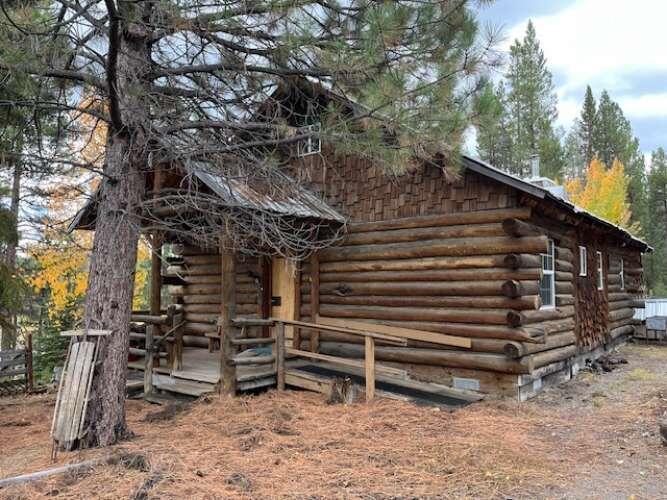 Secluded 2 Bed, 1.5 Bath Cabin on 4.86 acres with River frontage. The home is 700sq. ft. with many handcrafted features from lumber milled from the property. Landscape is mostly variety of Lodgepole and Ponderosa Pine Trees. Post and Pier foundation. The home has been empty for several years and will require attention in the plumbing, electrical box and balcony.