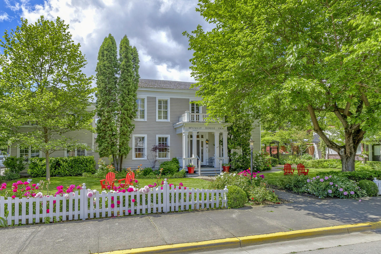 The luxurious McCully House is nestled in the heart of Jacksonville Oregon's Historic District, a designated National Historic Landmark and one of the nation's top 10 small towns. The inn is the oldest home in Oregon currently operating as an inn and has been featured in both Sunset & Gourmet magazine. The home was built in 1861 by John McCully, Jacksonville's first doctor & Justice of the Peace. The boutique inn offers six distinctive deluxe guest rooms and three luxurious suites, as well as a large wine bar/restaurant and full commercial kitchen. Every possible attention has been paid to the smallest of details. It has all the amenities you would expect in a metropolitan setting but is situated in a convenient downtown location on ¼ acre and includes a flourishing English garden and a private outdoor patio area.