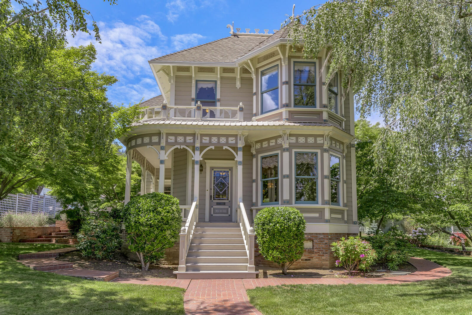 A highly visible part of Ashland's architectural heritage, this Italianate style home was built adjacent to the downtown commercial district in 1890 for Kate Grainger and G.M. Grainger, a two term Ashland mayor, who oversaw significant community growth including the construction of City Hall. When building was completed by architect W.J. Schmidt the home was called one of the prettiest cottages in town by the Ashland Tidings. The main house has two levels and features 3 beds and 3 baths with 10' ceilings throughout. The attached guest studio is single level and includes 1 bed and 1 bath. Stylistically unique in the neighborhood with a two story bay with turret and a curved veranda the home is in great condition having maintained the original period details including Fir flooring, wood paneling, and 10'' baseboards with molding. Newer updates include a spacious tile patio, two separate 2-car garages, and a modern foundation. The oversize .46 acre lot may be split according to the city.