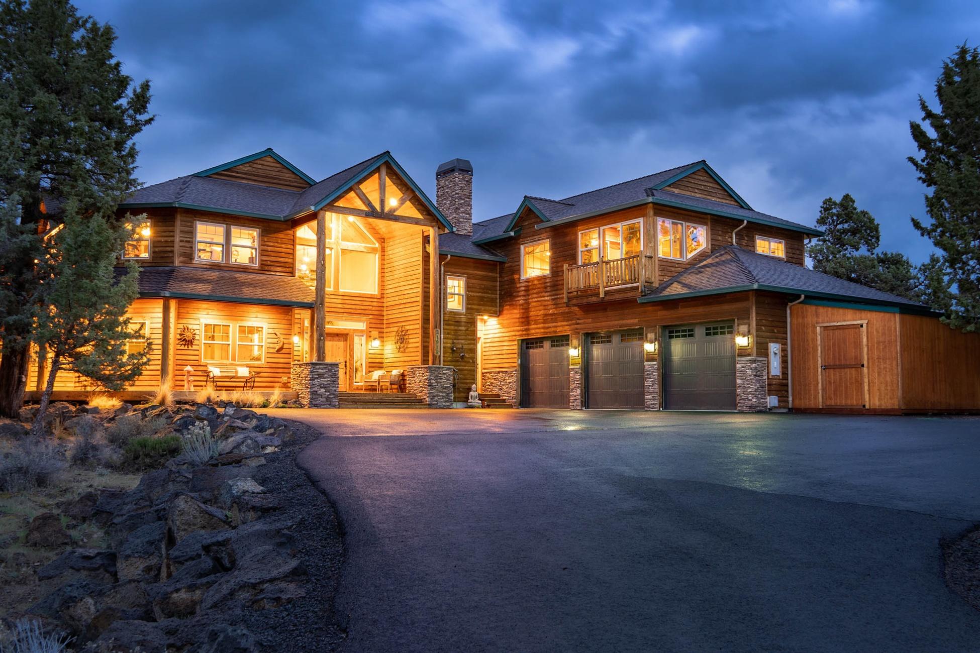 This stunning custom home in Boonesborough sits on 2.78 AC of wild desert landscape. Enter the home through a huge vaulted entryway and take in the knotty
pine, hand-hewn accents. Saltillo tile floors in the entry and kitchen areas bring a slightly southwest vibe to this lodge-style home, while high wood-plank ceilings and rope trim stay true to the home's Northwest heritage. On the ground level, find 4 guest beds plus a Master bedroom, which features a private deck,
walk-in closet, and spa-like bathroom. Upstairs, on the main living level of the home, find a great room with Cascade views, a large dining area, and a sunny
gourmet kitchen with hickory cabinets and breakfast bar. A bonus room and office are also on this level. A huge guest wing with access from both inside and out comprises the east end of the home and features a living room, kitchenette, sunroom, deck, and master suite. Outside, find an attached 3-car garage w/ shop space, detached shed, fenced area, & water features.