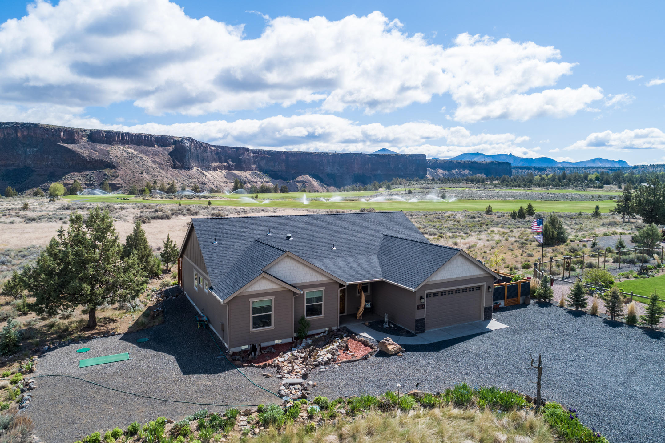 ON THE GOLF COURSE, Newly built at the direction of a discriminating owner. This 3 bedroom home provides all you could hope for; custom cabinetry, granite, hardwoods and tile, beautifully finished with gracious vaulted spaces. The property, with rare golf course frontage, has stunning Crooked River rim and golf course views, through a wall of floor-to-ceiling windows. Artistically designed, low-maintenance landscaping, as well as a fully fenced/gated courtyard-garden, blend beautifully with the natural rock exterior accents and aggregate concrete patios and walkways. Interior spaces include walk-in closets, kitchen pantry, luxurious master en-suite with double vanity, soaking tub and 5' tile shower, with frameless glass shower door. A tiled gas Fireplace provides a cozy ambiance and a 11'X16' heated, studio/hobby room/shop that gives you just enough extra space, with access from attached garage and courtyard, coupling the practical with elegant serene space.