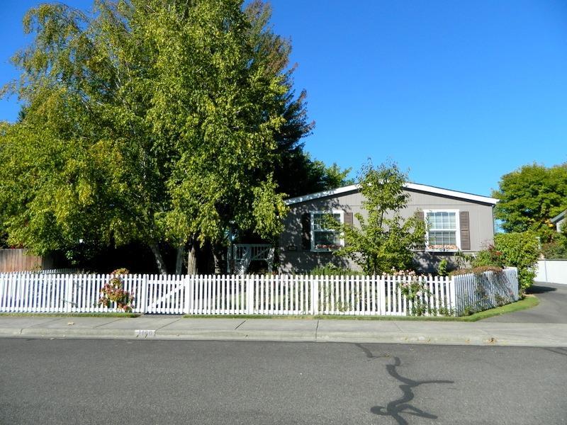 Spacious Home tucked under large shade trees. Meticulously maintained 3 bdrm 2 bath, 1620 Sqft home on .22 acre lot with abundant natural lighting, Large covered deck greets you every time you come home. Split bedroom floor plan, with large living room featuring Vaulted ceiling. Kitchen with pantry, skylight, extra counter space and breakfast bar. Sunny dining room. Master bedroom with walk in closet plus linen closet. Master bathroom has tub, separate shower & double sinks. Extra bedrooms are spacious. Laundry room. Super Clean. Fenced yard, automatic sprinkler system. Single garage and portable carport.