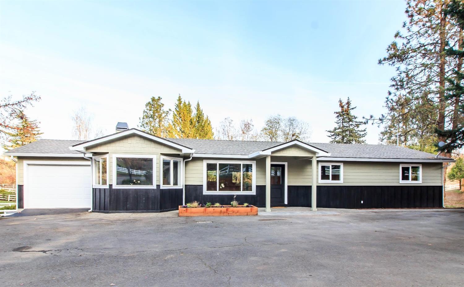 Fully remodeled 1960's vintage home has been completely updated to present day style and conveniences. Brand new white cabinetry, granite countertops, new flooring, electric and plumbing. This home is an oasis for country loving people that desire the privacy and beauty of the country with the ease of getting to town in just a few moments. This lovely home features an open floor plan with fireplace and an amazing deck for everyday living and easy entertaining. This is a 3 bedroom, 2.5 bath home on the main level with a beautiful family/guest suite that has its own full level with a bedroom and full bath and privacy for you and your guests. In addition to the home on this 1.03 acre irrigated lot is an additional garage/shop building that is 700 square feet, RV parking. The yard is a wonderful setting for a large garden and amazing relaxing entertaining.