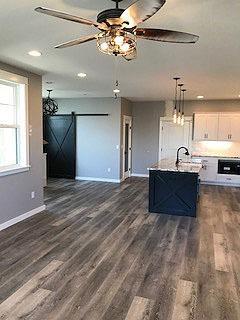 This home stands above the rest with multiple upgraded amenities. New construction. Main level kitchen, laundry room, walk-in pantry with glass etched door, living room, master bed/bath, dining, covered patio with fans, 1/2 bath, sliding barn door, black distressed island, top grade granite counter tops and industrial looking lighting. All cabinets have self closing drawers, upgraded black stainless steel appliances. 1/2 bath off the front of the home, large windows throughout with views of Grizzly Peak. Covered/partially enclosed patio off the eating area with lighting and outdoor fan. Finished 1 car garage with additional side parking next to the garage. Master suite is located off the living room and features a large walk-in closet with sliding barn door and spa like master bath with walk-in shower that is a show piece. Upstairs vaulted, 2nd large great room, views, 2 bedrooms and bath. Listing agent is related to seller.