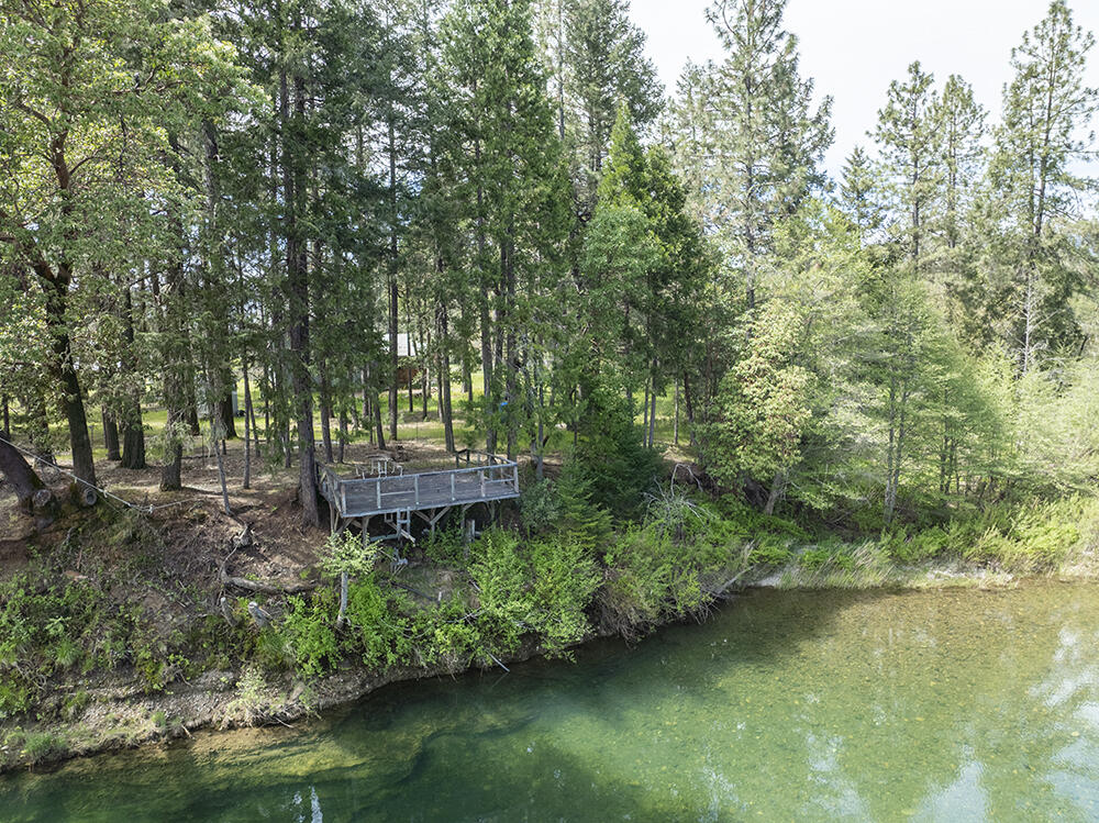 Contractor's Special on the Illinois River! Motivated Seller so don't miss this unique opportunity! Looking for privacy, space, and irrigation with riverfront charm? This 6.5-acre property spans two tax lots and offers excellent potential for agricultural use, including vineyard expansion. A Water Rights Certificate provides two acres of irrigation from the Illinois River, complete with a pump and sprinkler system already in place. The spacious 3-bedroom, 3-bath farmhouse is a work in progress, with quality upgrades underway. Bring your vision to finish it your way! With ample room for entertaining and comfortable living, this home is ready for its next chapter. Check with Josephine County Planning for options to build a second residence. Explore the possibilities and unlock the full potential of this riverfront offering. Seller is ready to make a move, schedule your showing today! Buyer to perform all due diligence.