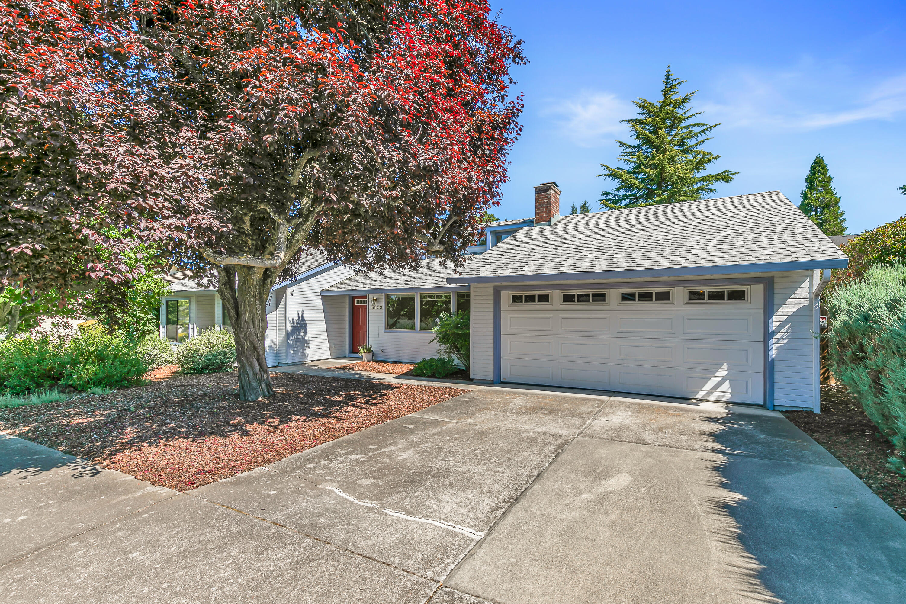Tucked away in a quiet East Medford subdivision, this inviting home offers a nice blend of comfort and recent updates. Inside, you'll find fresh touches throughout—including brand new carpet in all three bedrooms as well as updated LVP flooring and a new shower stall in the primary bathroom. The spacious living room features vaulted ceilings and a cozy wood burning fireplace, creating a warm, open feel. The kitchen offers classic wood cabinetry and an efficient layout that's both functional and easy to personalize. Enjoy peace of mind with a brand new composition roof installed in 2025, and a water heater replaced in 2015. Step outside to a fully fenced backyard surrounded by mature trees and tall hedges—your own private oasis. An oversized two car garage allows for plenty of extra storage space. Clean and move-in ready, this home is a great find located in a convenient neighborhood close to shopping and medical services.