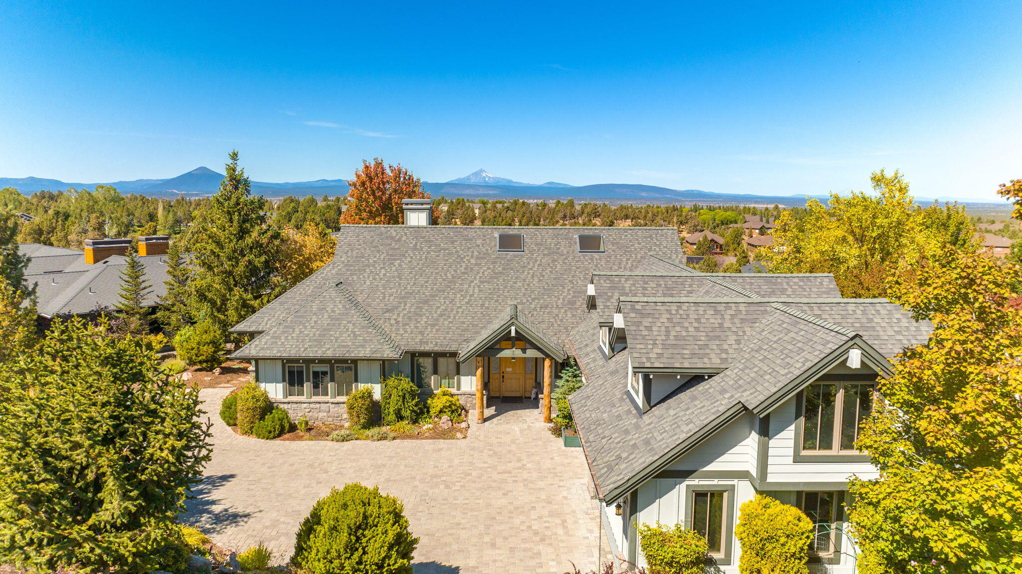 Welcome Home! Enjoy spectacular Cascade Mountain views from this beautiful custom home in Eagle Crest Resort! Single story living including great room with 17' vaulted ceilings, exposed timber trusses, solid granite wood-burning fireplace, wrought iron door, & juniper mantel. Cook in this dream kitchen with slab granite countertops, high-end appliances, & custom wet bar. The primary suite has huge closet, soaking tub & walk-in shower. Main floor also has 2 guest suites (one wired for kiln to make an artist paradise), den, half-bath, and utility room.  Upstairs is a large bonus room with closets & a full bath. 3-car garage has an epoxy floor. Outside is landscaped sprinklers front and back. Take in the views from the paver deck with a hot tub and gas fire pit. As an investment, Ironstone Lodge paid out over $135,000 after management fees & taxes in 2022 and over $98,000 through September 2023. This is a fabulous opportunity to own a turn-key executive home with full furniture package.