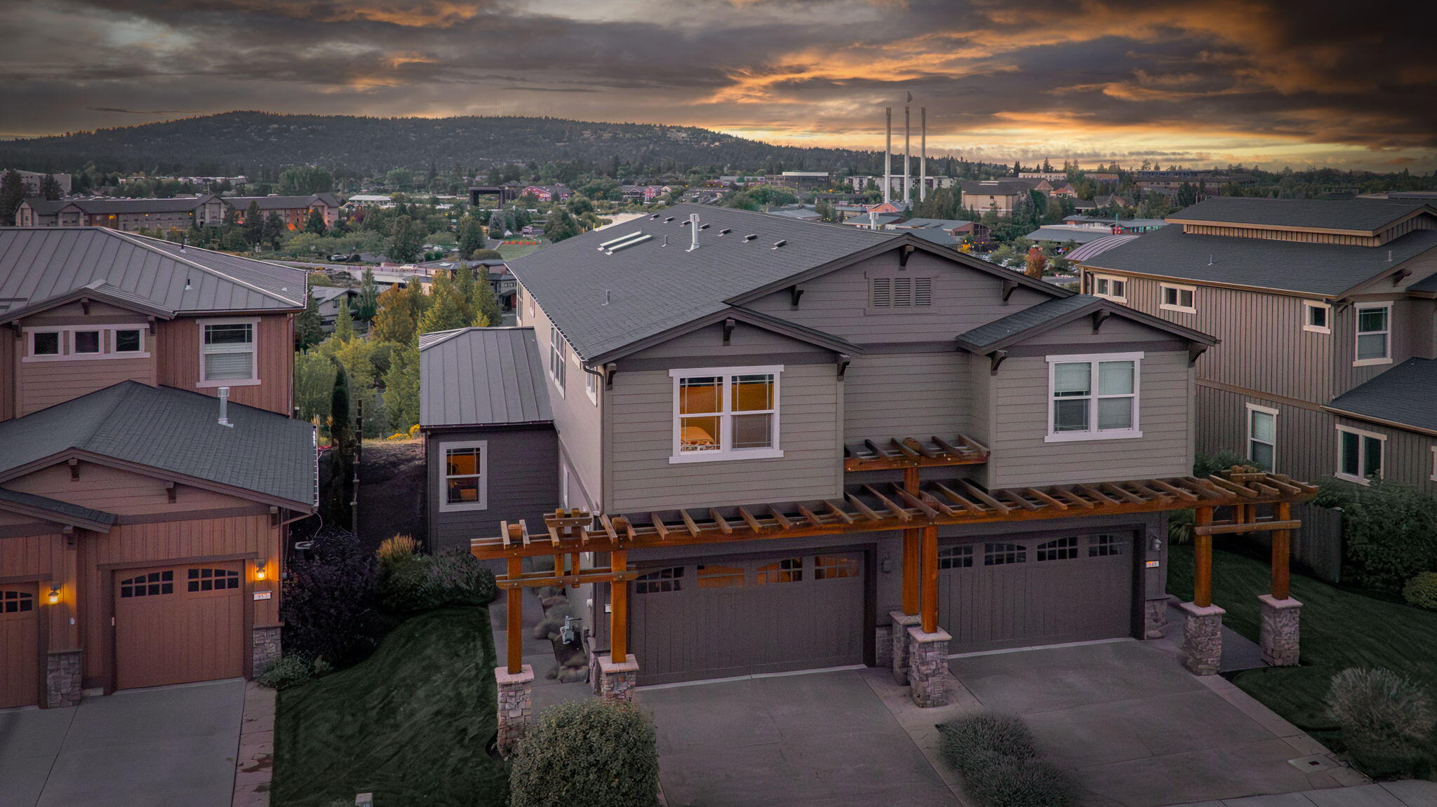 Nestled just steps from the iconic Old Mill, this home has sweeping panoramic views of the Cascade Mountains and the Deschutes River. Expansive windows flood the open-concept living area with natural light,  framing the stunning scenery. The gourmet kitchen is complete w/ gas range, knotty pine cabinetry, generous pantry, and an inviting eat-in island. Step outside onto the heated deck, where you can relax and savor sunsets over the mountains. A main-floor bedroom and full bath offer ideal flexibility for guests or home office. Upstairs, discover a versatile loft, perfect for a media room or home gym. The primary suite boasts incredible views, a private balcony, 5-piece en-suite bath w/ soaking spa tub, and spacious walk-in closet. Two large bedrooms and a full bath complete the upper level. The garage has a 240V outlet for your EV.  Imagine enjoying a concert at the amphitheater from the comfort of your deck or watching tubers float down the river. Your slice of paradise awaits!