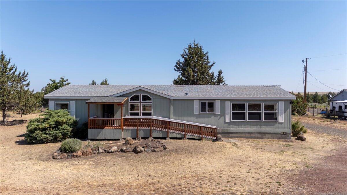 Discover the potential of this fantastic property, perfect for investors, flippers, or those looking to create their dream home with a bit of sweat equity. Nestled on 1.25 acres adjacent to the National Grasslands, never have anyone build behind you. This home boasts beautiful wood laminate floors throughout. The spacious master bedroom features double French doors, a walk-in closet, and a private bathroom. With two living rooms and a centrally located kitchen, this home offers plenty of space for relaxation and entertainment. The newly installed heat pump will keep the whole house cool in the summer and warm in the winter. The highlight of this property is the oversized new garage 22x30, with a powered roll-up door, providing ample space for vehicles and storage. The flat lot offers endless possibilities for your vision. Don't miss out on the unique opportunity to own a piece of potential!