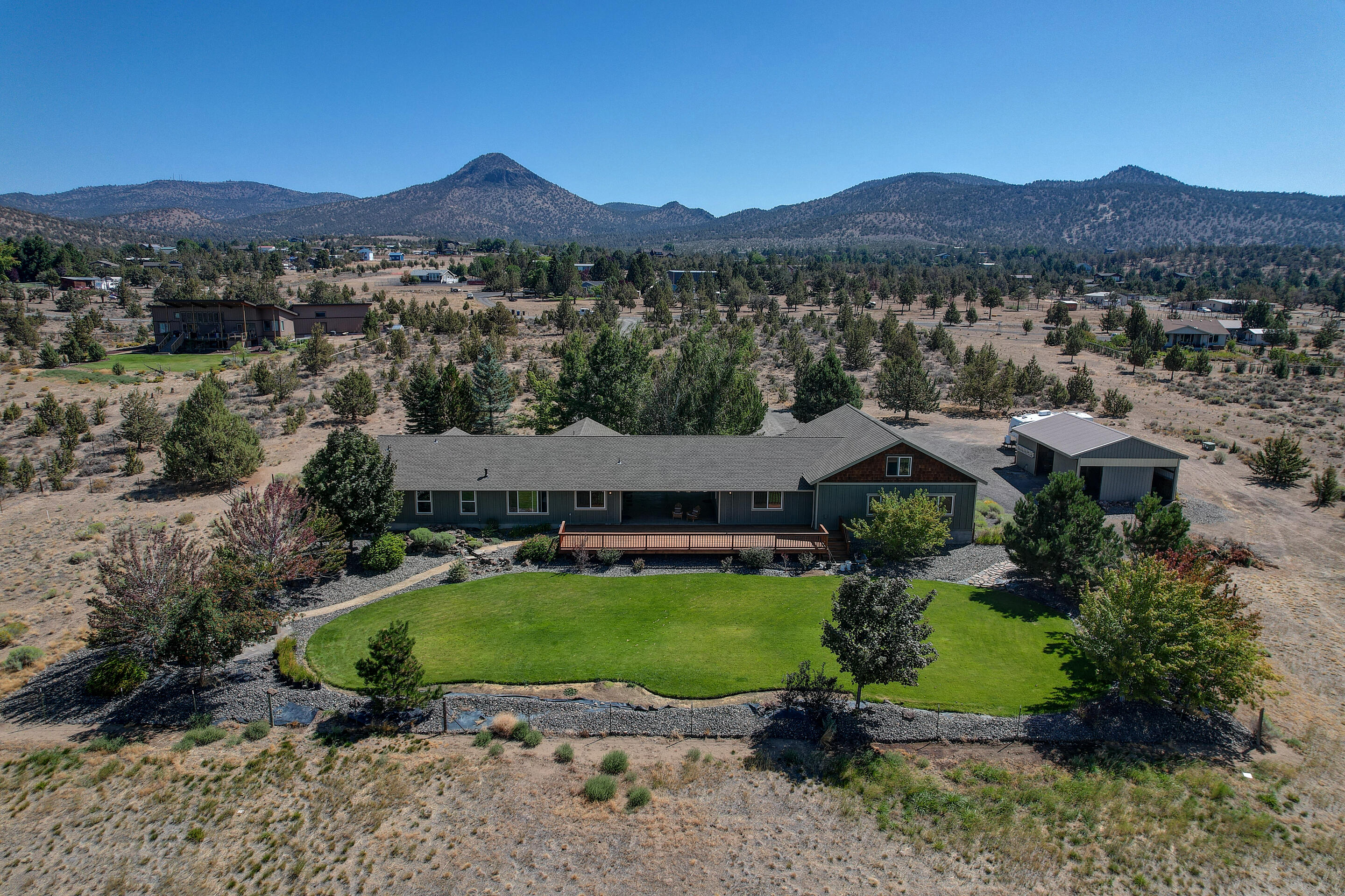 Retreat to your private oasis with breathtaking views on 9.94 acres. Open floor plan and expansive back deck. Main home is 1,942 sq ft and connects via covered stamped concrete breezeway to 2 bonus rooms that could be used for multiple things such as an office  or home gym. Shop, finished garage and loft providing and additional 2,125 sq ft, the possibilities are endless.
Paver patio/sidewalks, firepit, landscaped with water feature and auto irrigation.
Bring your toys and animals, barn has 2 stalls.
7000 gallon cistern used in conjunction with well as holding tank this home has everything you need to be comfortable.
There is a possibility to subdivide and owner has a proposed sketch that was acceptable by the County at one time. See attached documents.
