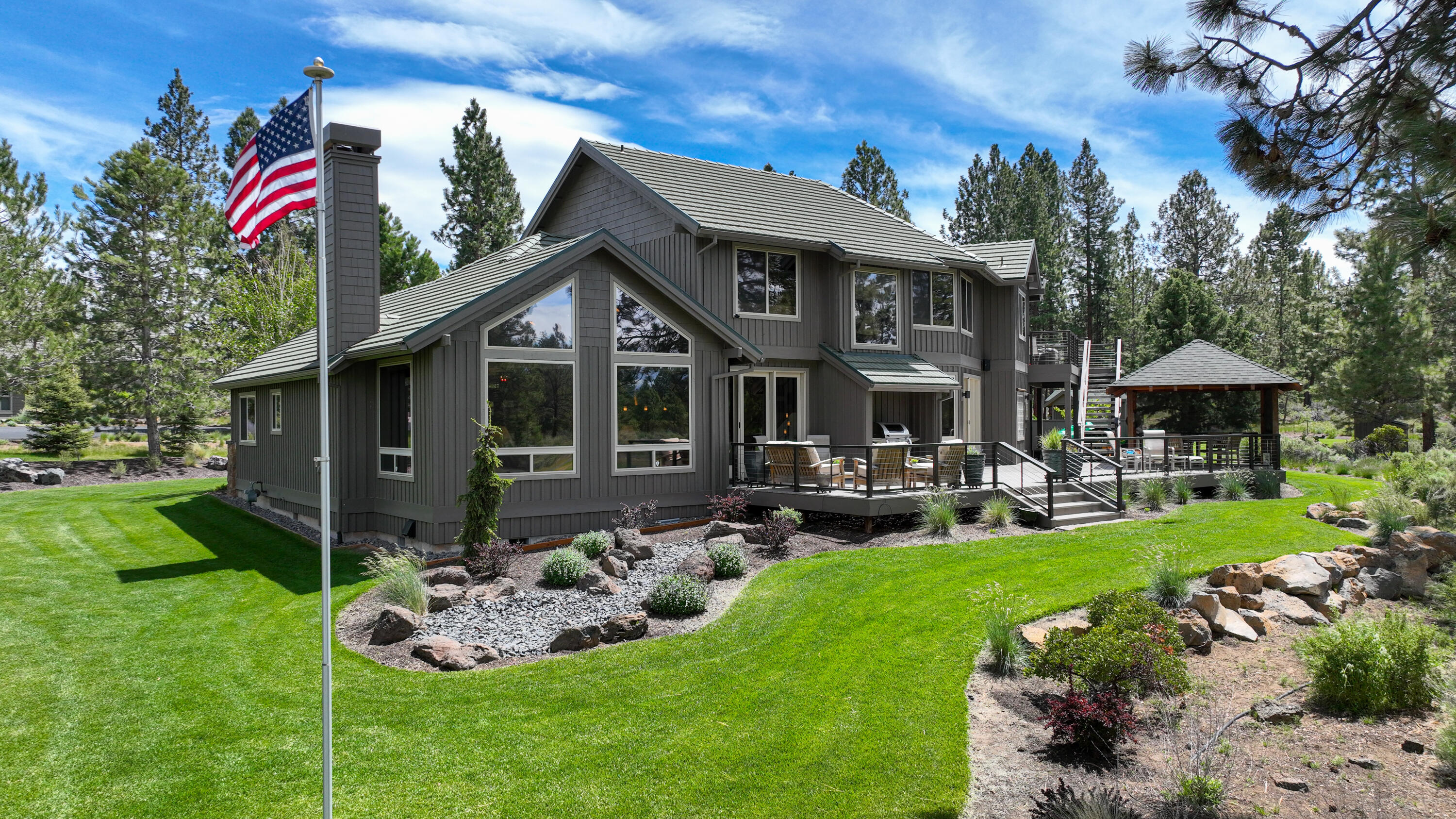 Enjoy life in this beautiful mountain-modern style home in the gated community of Sunset View Estates. The 1.24 acre property offers panoramic views of the golf course & Cascade Mountains & is just minutes from downtown Bend. The great room features a floor to ceiling Montana Moss Rock gas FP.  Porcelain tile floors on the main level boast zoned radiant heat.  Extensive updates to the main floor include the enlarged kitchen, pantry, and laundry.  Kitchen is a chef's delight with high- end stainless steel appliances, quartz countertops, large island w/ prep sink. The primary suite location has great views & is nicely separated from the guest bdrm & full bath. A spacious laundry room w/ sink & 4 car-garage, completes the main level.  Upstairs space includes 2 Jr Suites, a 2nd primary suite, a compact laundry room, bonus room & another bonus space. Complete redesign of the landscape, including water feature, garden house, screened area next to garage, new driveway, & irrigation system.
