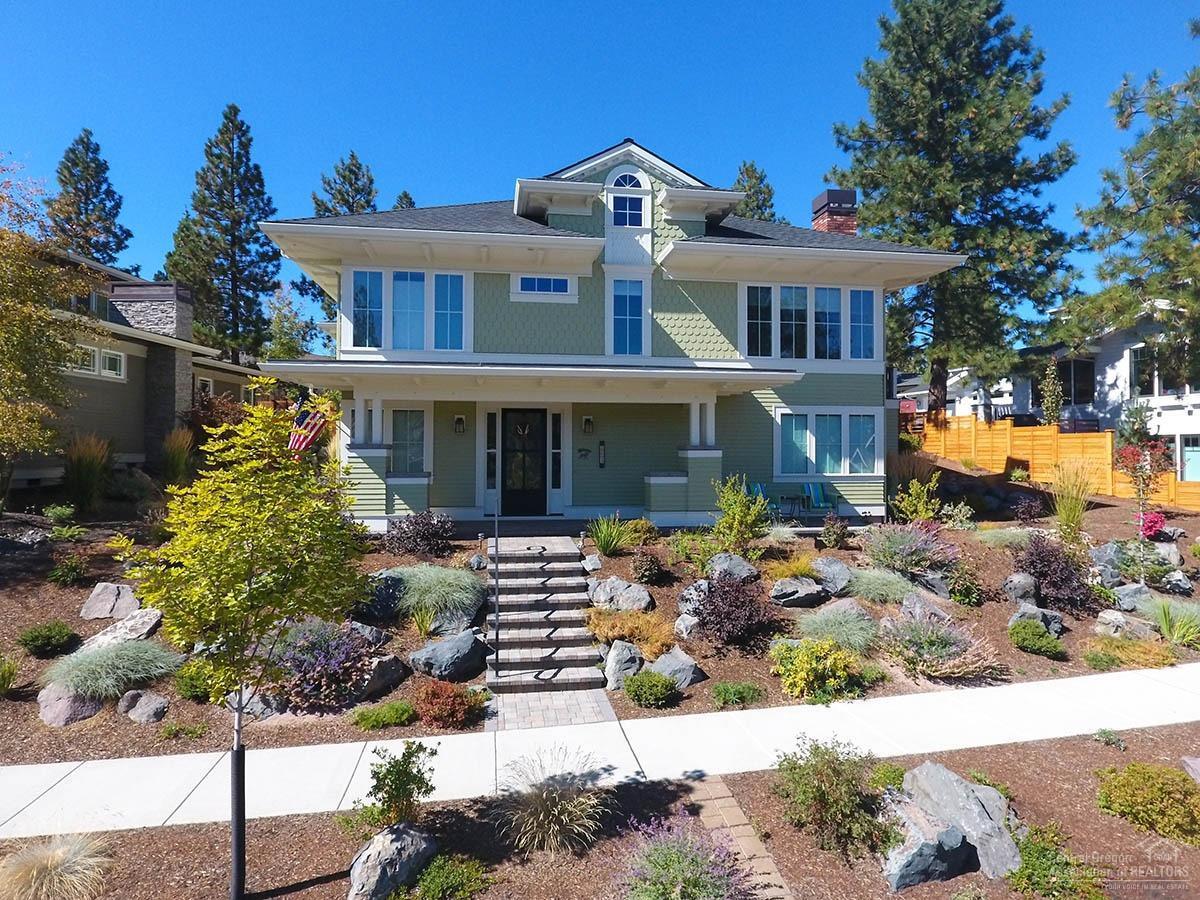 Impeccably kept home displaying European style influences with main level living from the oversized garage off the back alley. On this floor you'll find the master suite, great room with gas fireplace, a gorgeous chefs kitchen, 2nd bedroom/Den, Full bath & utility room. Sidewalk level leads to the open foyer, family room, two bedrooms & 1.5 baths. Spacious rooms & large windows throughout makes this a bright & cheerful home! Excellent back yard, fully fenced with a built in gas fire pit surrounded by a entertaining size paver patio. This is an Earth Advantage Gold certificate home.