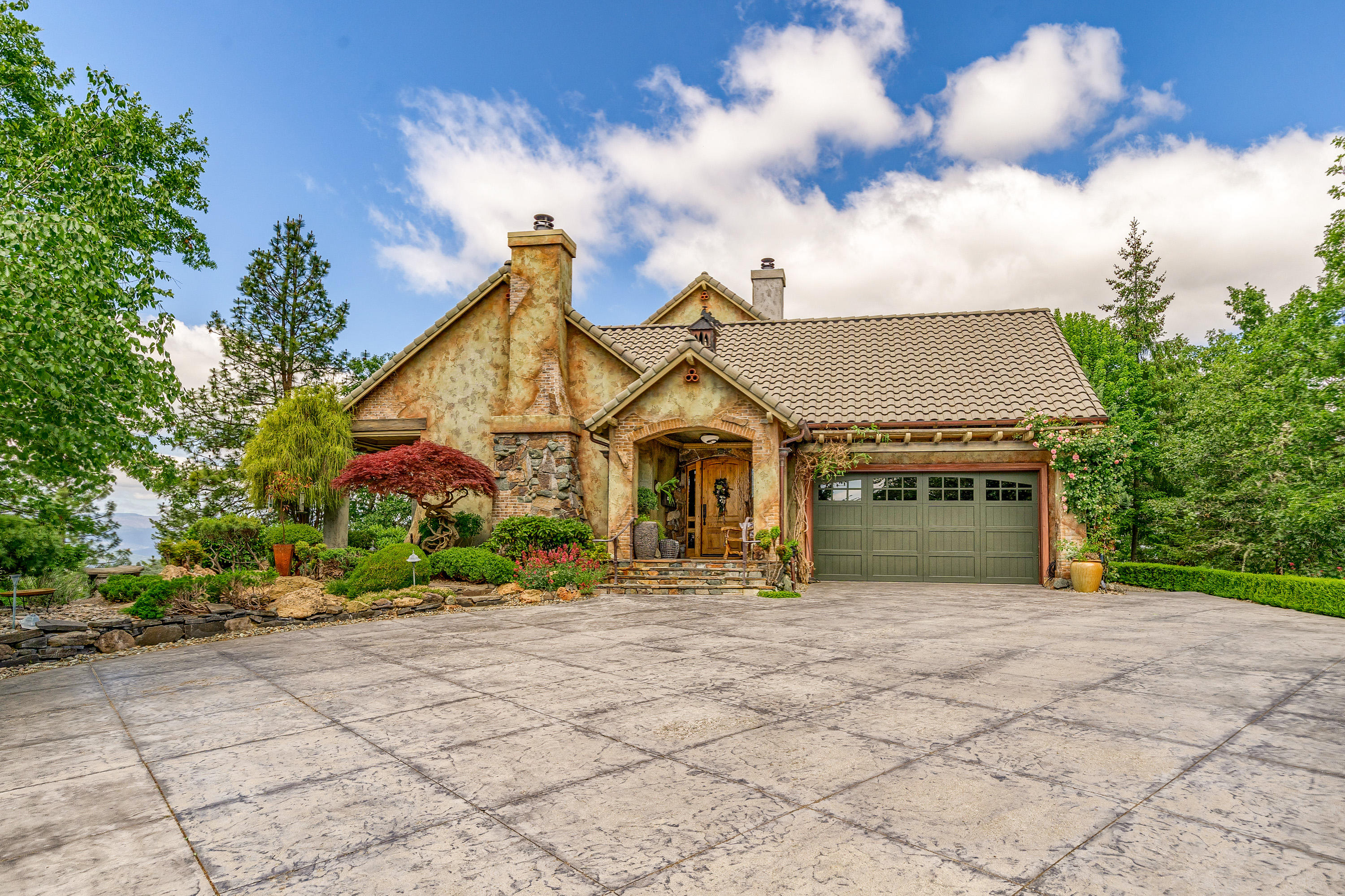Extraordinary does not even begin to describe this custom estate property. Panoramic views from this 14.44 knoll top setting. Incredible quality and attention to detail in every corner. Open floorplan, barrel vault & box beam ceilings. Gourmet kitchen w/island and prep sink. Top of the line stainless appliance, cabinets galore. Living and family rooms boast fireplaces, and each are fabulous for entertaining. Custom interior and exterior paint. Copper gutters, numerous courtyards, firepit, sitting areas and meticulously maintained landscaping. Main level Owner's Suite w/ adjoining office, dressing room, spa-like bathroom w/ steam shower and laundry room. Upstairs are two additional guest rooms with en-suite bathrooms and private balconies. Huge craft room/rec room with skylight and abundant storage. Extensive hardscape including decorated stamped concrete, paver and flagstone patios and the list goes on. Estate setting with incredible privacy yet close to town.