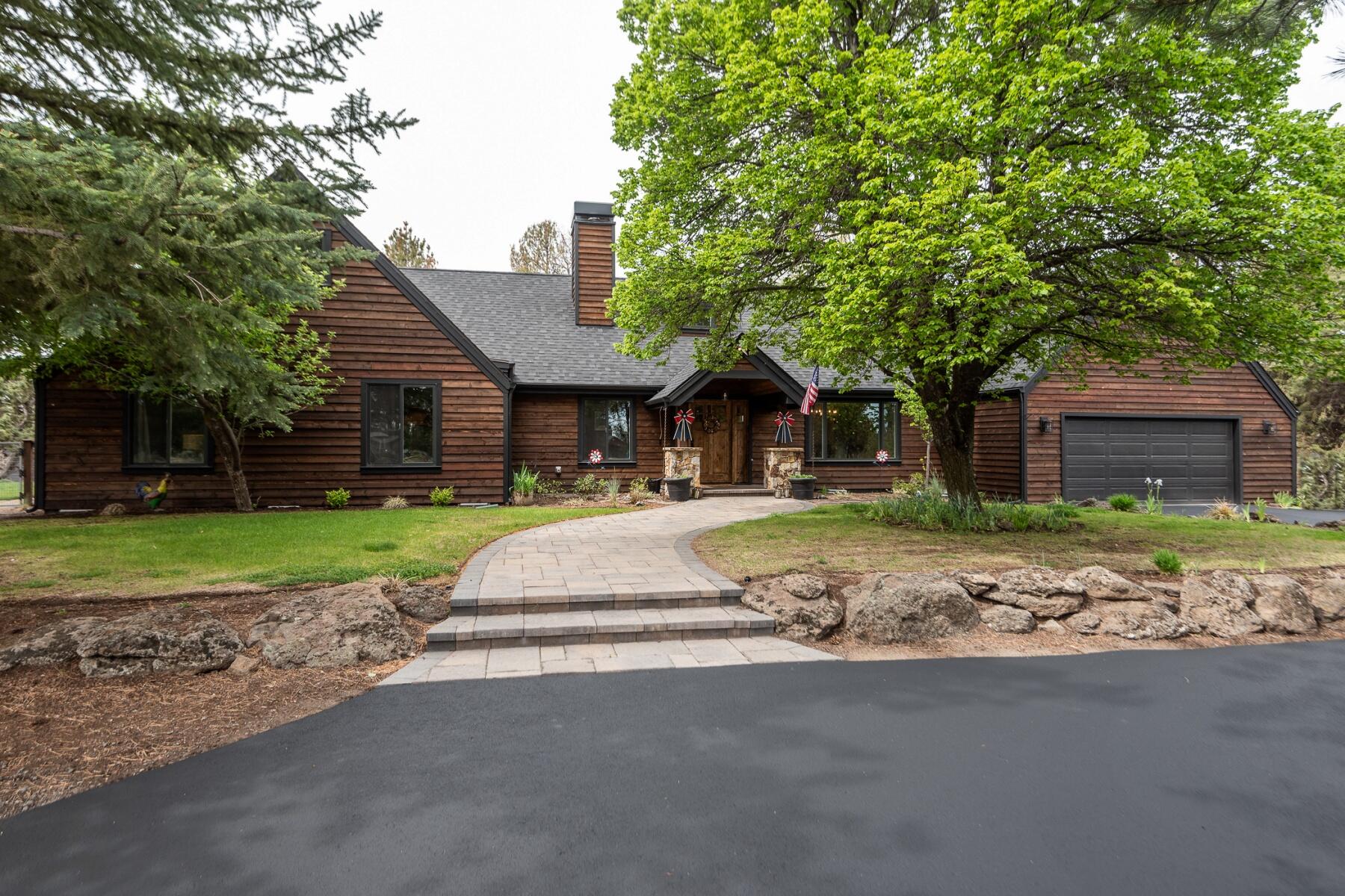Taken down to the studs & rebuilt in 2021, this like new home is warm & welcoming. Sitting on 2.28 private ac, this killer property is stunning inside & out. Completed w/4 bd, 2.5 ba, & bonus w/wet bar. The designer kitchen has ample cabinet & cupboard space, open shelving, quartz counters, black stainless appliances, & an island w/bar seating, that opens to the living & dining room. The main level primary suite has a walk-in closet, dual vanity w/quartz counters, & a walk in shower w/multiple heads. Additional features incl. a floor to ceiling stone fireplace, custom woodwork & built ins, a large mud/laundry room, & an oversized 2 car garage w/epoxy floors. The fenced, gated property includes a newer 56'x58' finished, heated shop w/four 14'x 12' doors, 220 AMP power, RV hookup w/50 AMP power, chicken coup/greenhouse, paver patio w/firepit, & Cascade views! Great location w/easy access to Hwy 97 & conveniently located close to Bend, Tumalo, & Redmond. Don't miss this rare opportunity!