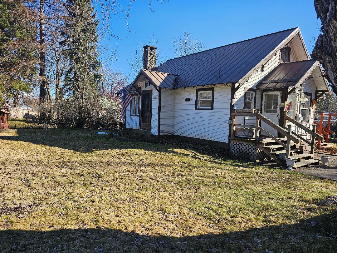 Cozy Cottage in the Country on 1/2 acre. 
20 x 24 Finished Garage. Matching tough shed. Green house, fenced garden(s), Creek. Vintage interior, lots of natural light, high ceilings. Original wood floors (currently under carpet) & built ins. Rock FP w/ propane insert. Public water/sewer. Full basement. Cozy Cottage in the Country. Very near Pine Hollow reservoir, Rock Creek reservoir, MHNF, ODFW & BLM lands.