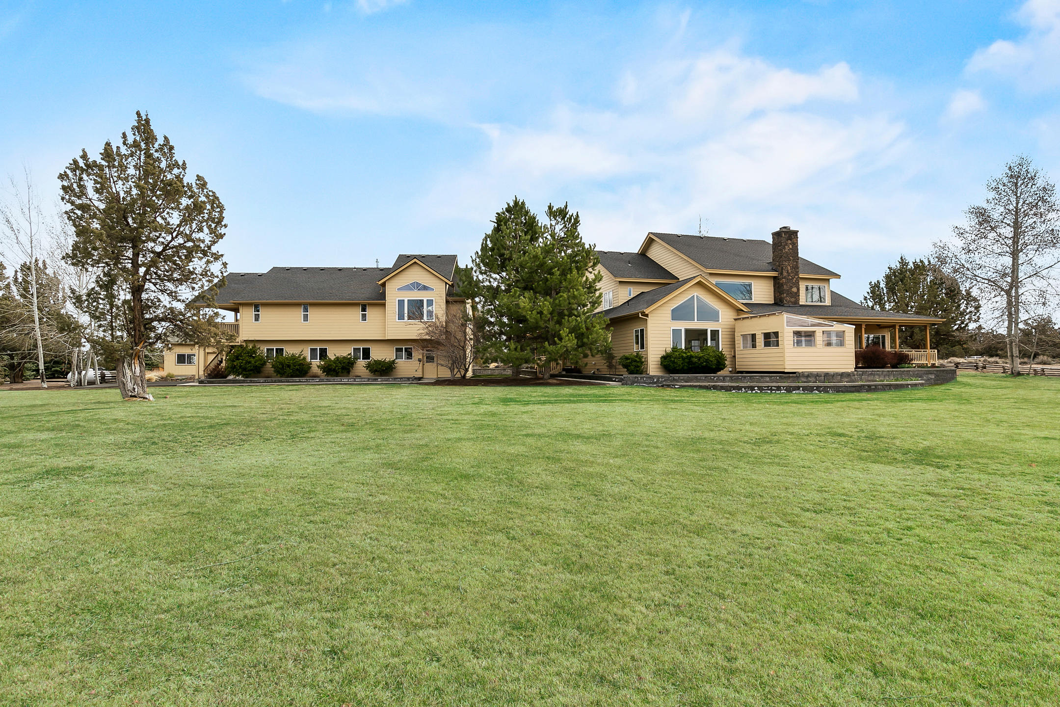 Beautiful private country estate in gated community on 20 acres. Magnificent views of the Cascades, guest house, shop, backs BLM, in ground sprinkler and drip system, immaculate mature landscaping. Gourmet updated kitchen, 2 sinks, kitchen island, propane cook top and warming drawer, wine nook, extensive cherry cabinetry and spacious walk in pantry. Cherry floors, breakfast nook and bar. Open floor plan, primary bed on main, bonus room/loft w/privacy, mud room/laundry room has extensive cabinetry and sink. Wood burning fireplace with propane start and wood storage. Wrap around porch, covered deck on the west side of the house with propane hook up for your BBQ. 1554 Sq Ft guest house features 2/b 1/b, views of the cascades, kitchen and living area, propane heating stove, electric heat, heat pump, porch/deck. 3 bay oversized garage. 1700 SQFT shop, RV door and 10' door and att. garage. Generator sys. 1000 gal propane tank will automatically run the house, guest house, garage and sho