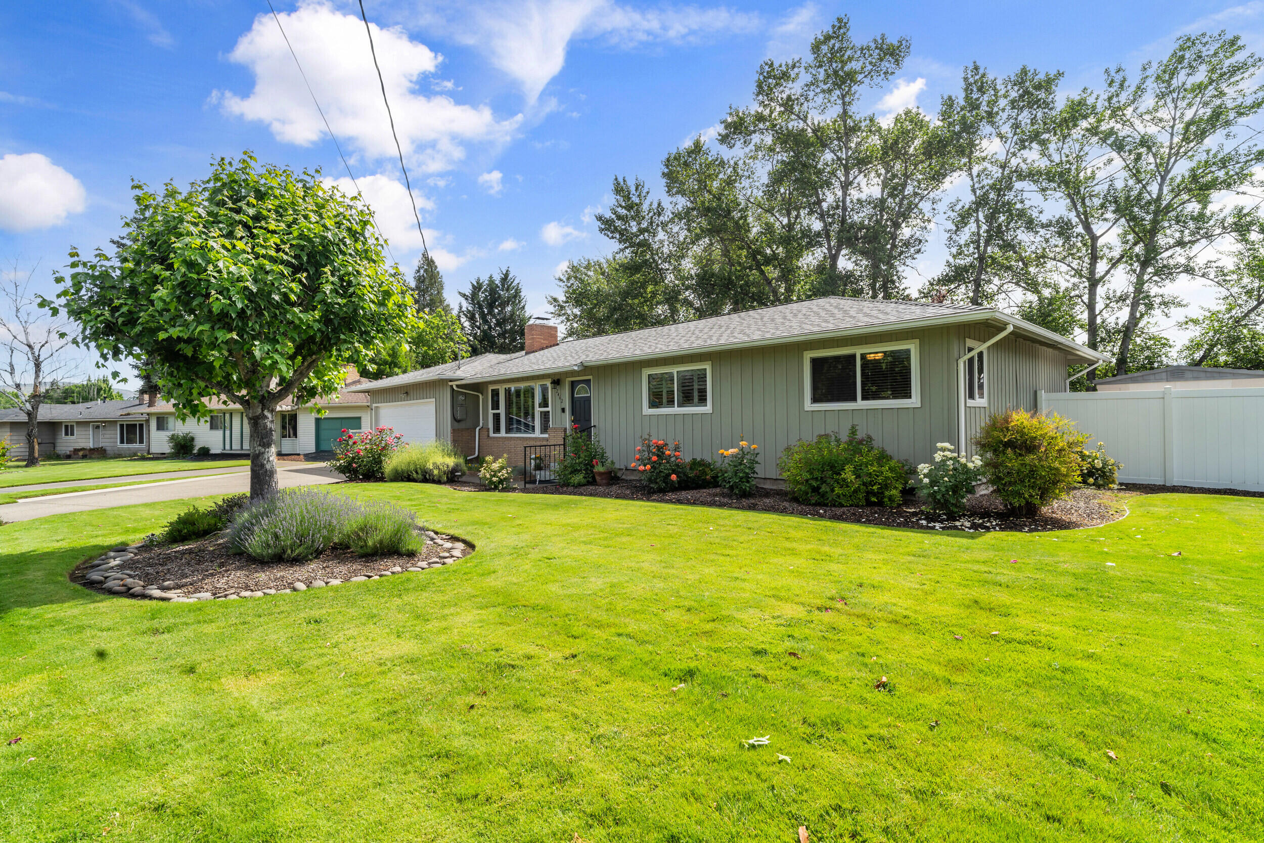 Tucked beside year-round Larson Creek, this well-maintained home blends comfort, functionality, and a peaceful outdoor setting. The landscaped yard offers mature trees, fruit plants, raised beds, and a misted covered patio ideal for relaxing or entertaining. Inside features include oak hardwood floors, plantation shutters, and a remodeled bath with semi-sunken tub and bidet. The 24x24 detached shop (576 sq ft) with pull-down attic access provides space for hobbies or storage. Den could be converted back to a 3rd bedroom. Recent updates include Milgard windows, R-38+ insulation, new central vac motor, updated HVAC, and newer roof. A 12-zone sprinkler and drip system keeps things simple. Move-in ready and full of charm!