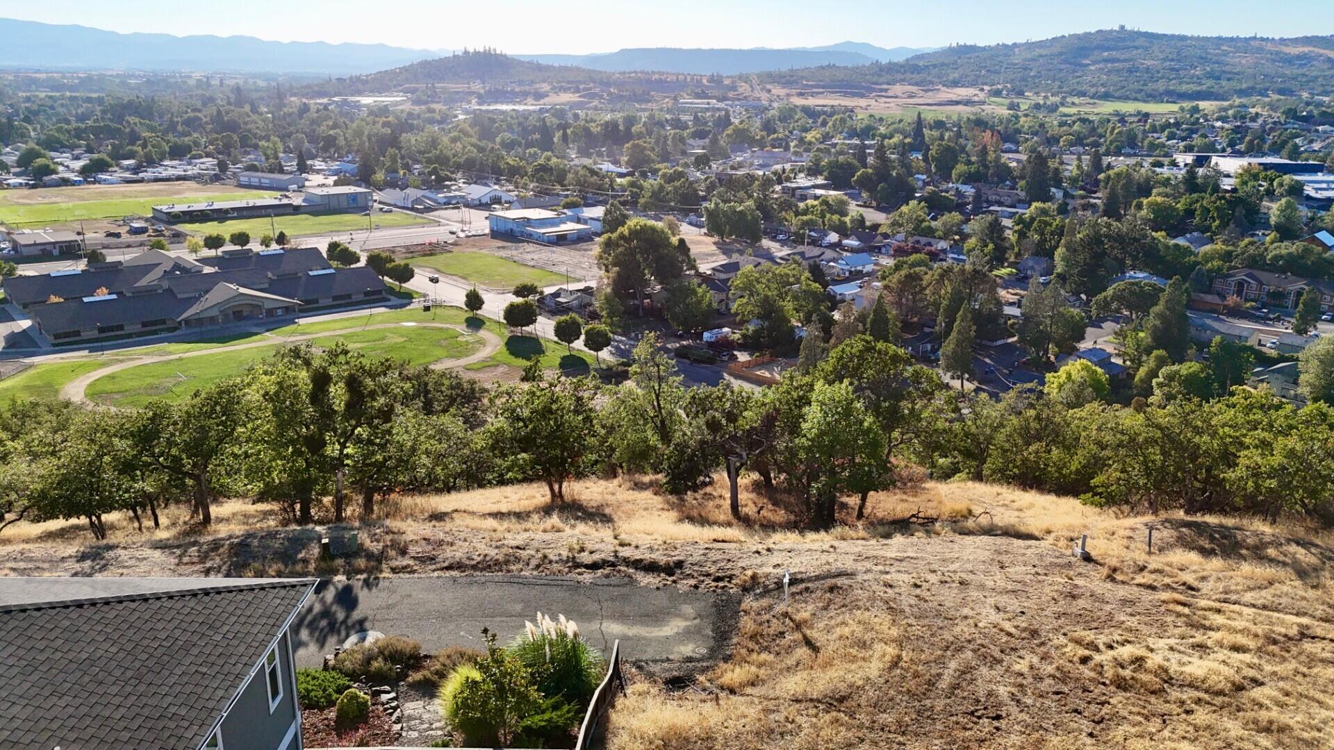 Build your dream home on this exceptional home-site in the Eagle View Subdivision. Ideally located at the end of the road, this spacious home-site provides rare privacy and sweeping mountain views, sparkling city light views, and wonderful sunsets. Just minutes from the Robert Trent Jones Golf Course, shopping, schools, and parks, it offers the perfect mix of convenience and serenity. Can't find the right home? Bring your custom home plans and builder—or use the available home designs to start building soon. With its prime end-of-subdivision location, stunning view lot potential, and ready-to-go status, this property is a rare opportunity in Southern Oregon. Don't miss your chance to secure this special home-site.