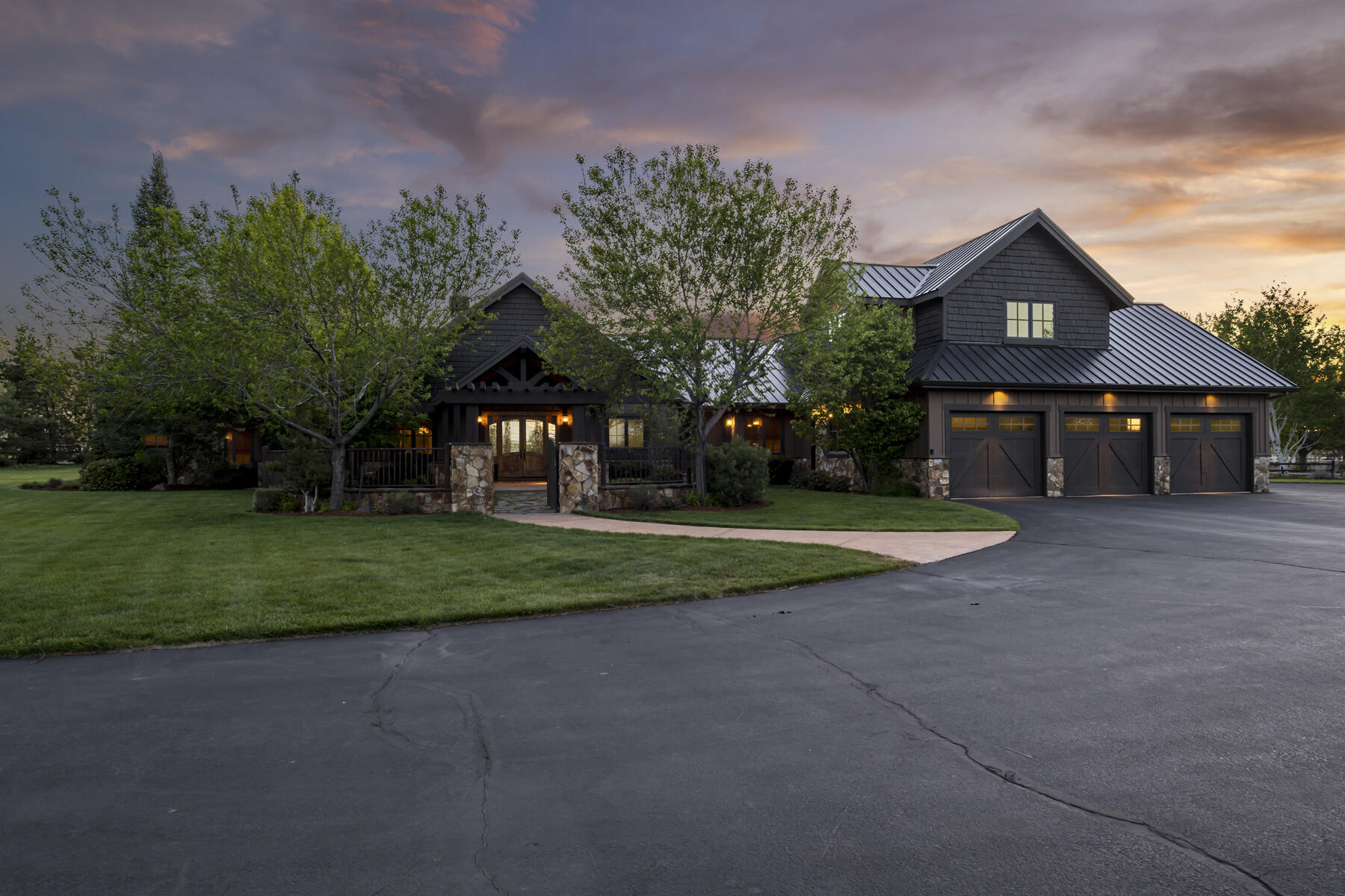 Nestled in the heart of Tumalo Oregon, this rare property spans 9.28 acres of manicured landscape and is accessed through a private entrance gate. The custom Northwest Home boasts stunning views of the Cascade Mountains and Cline Butte. The property features a pond, an expansive covered concrete patio, a stream flowing to your own 1.25-acre private lake with a dock, and a courtyard with a stone and iron gated entrance leading to the main house. Upon entering the front doors, a vaulted foyer with exposed beams welcomes you into the Great Room. The main house includes a private master wing, a library area or second office, 4 generously sized bedrooms, a 5th bedroom or gym space, a large mudroom, and a bonus room upstairs with a private deck. Additionally, there is a 2500 sq ft shop that includes a 912 sq ft private guest quarters. Only the highest exquisitely finished materials are used inside and outside, offering a true retreat to enjoy that's not too far from city amenities.